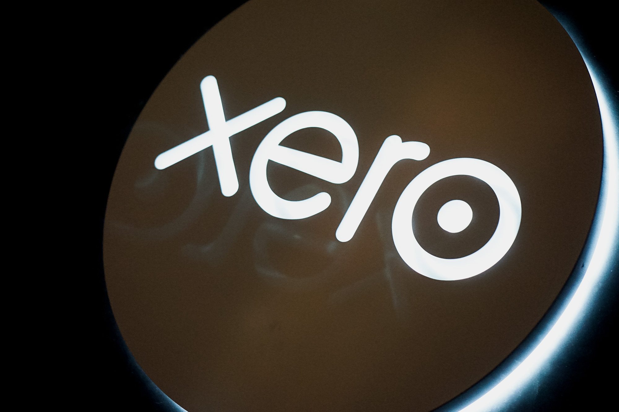 Illuminated, back-lit white sign on blue lobby wall for Xero, a cloud-based accounting software platform for small and medium-sized businesses. Illuminated, back-lit white sign on blue lobby wall for Xero, a cloud-based accounting software platform for small and medium-sized businesses.