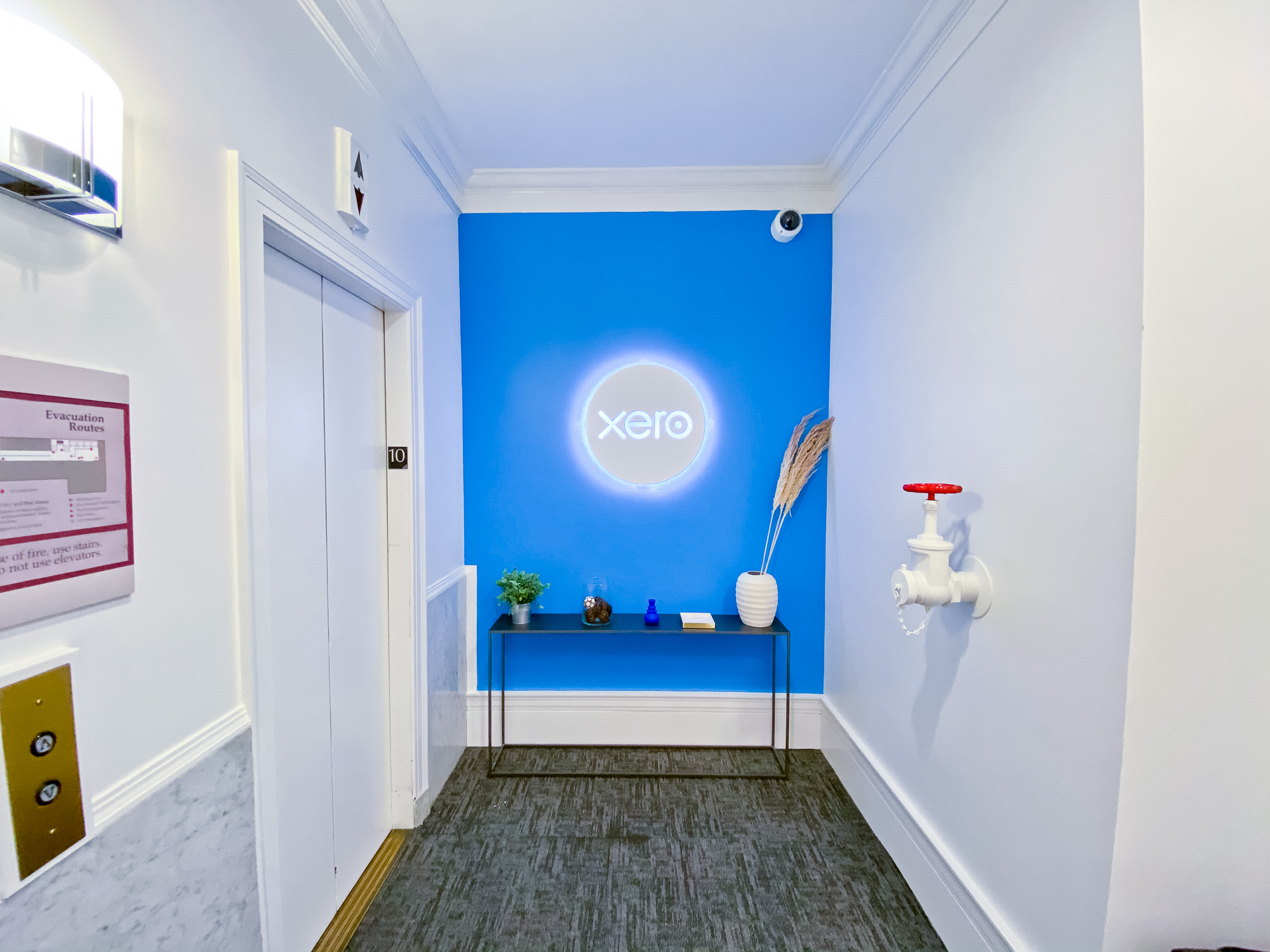 Illuminated, back-lit white sign on blue lobby wall for Xero, a cloud-based accounting software platform for small and medium-sized businesses. Illuminated, back-lit white sign on blue lobby wall for Xero, a cloud-based accounting software platform for small and medium-sized businesses.