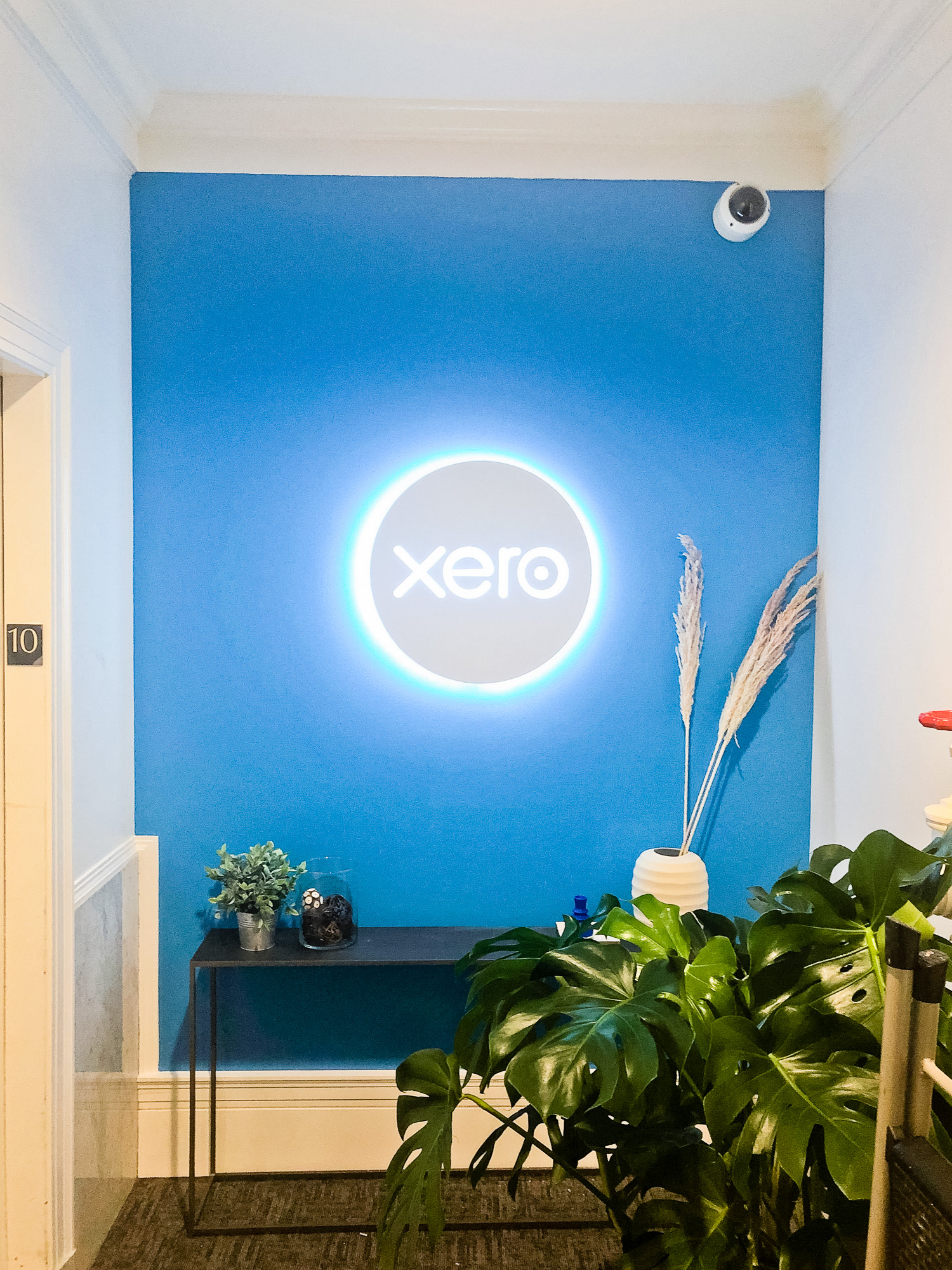 Illuminated, back-lit white sign on blue lobby wall for Xero, a cloud-based accounting software platform for small and medium-sized businesses. Illuminated, back-lit white sign on blue lobby wall for Xero, a cloud-based accounting software platform for small and medium-sized businesses.