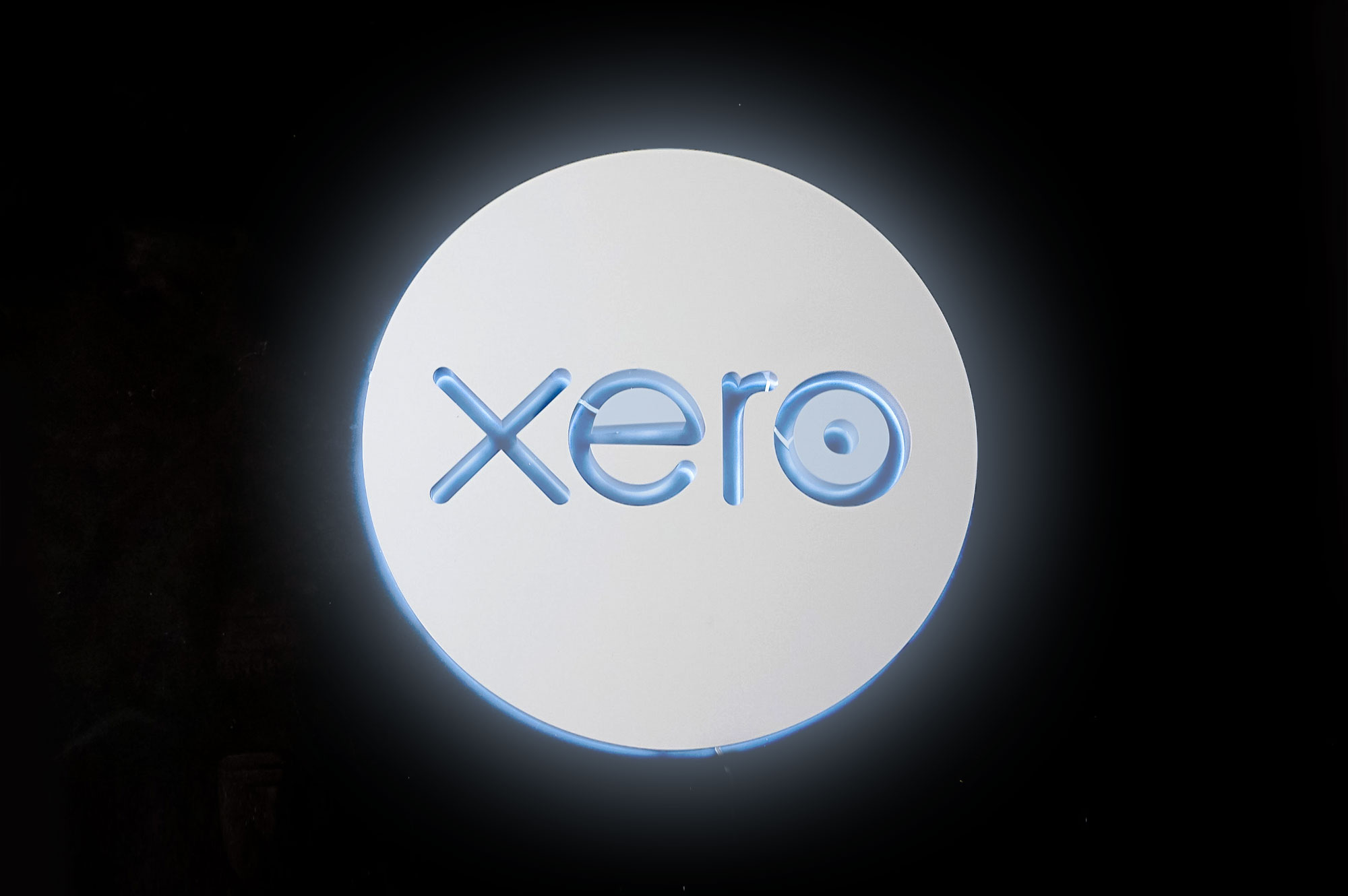 Illuminated, back-lit white sign on blue lobby wall for Xero, a cloud-based accounting software platform for small and medium-sized businesses. Illuminated, back-lit white sign on blue lobby wall for Xero, a cloud-based accounting software platform for small and medium-sized businesses.