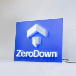 Back-lit, illuminated blue and white lobby sign for Zerodown, a company that couples technology and a debt-fueled real estate fund to allow home-buyers to forgo the traditional down payment process required to purchase a home.