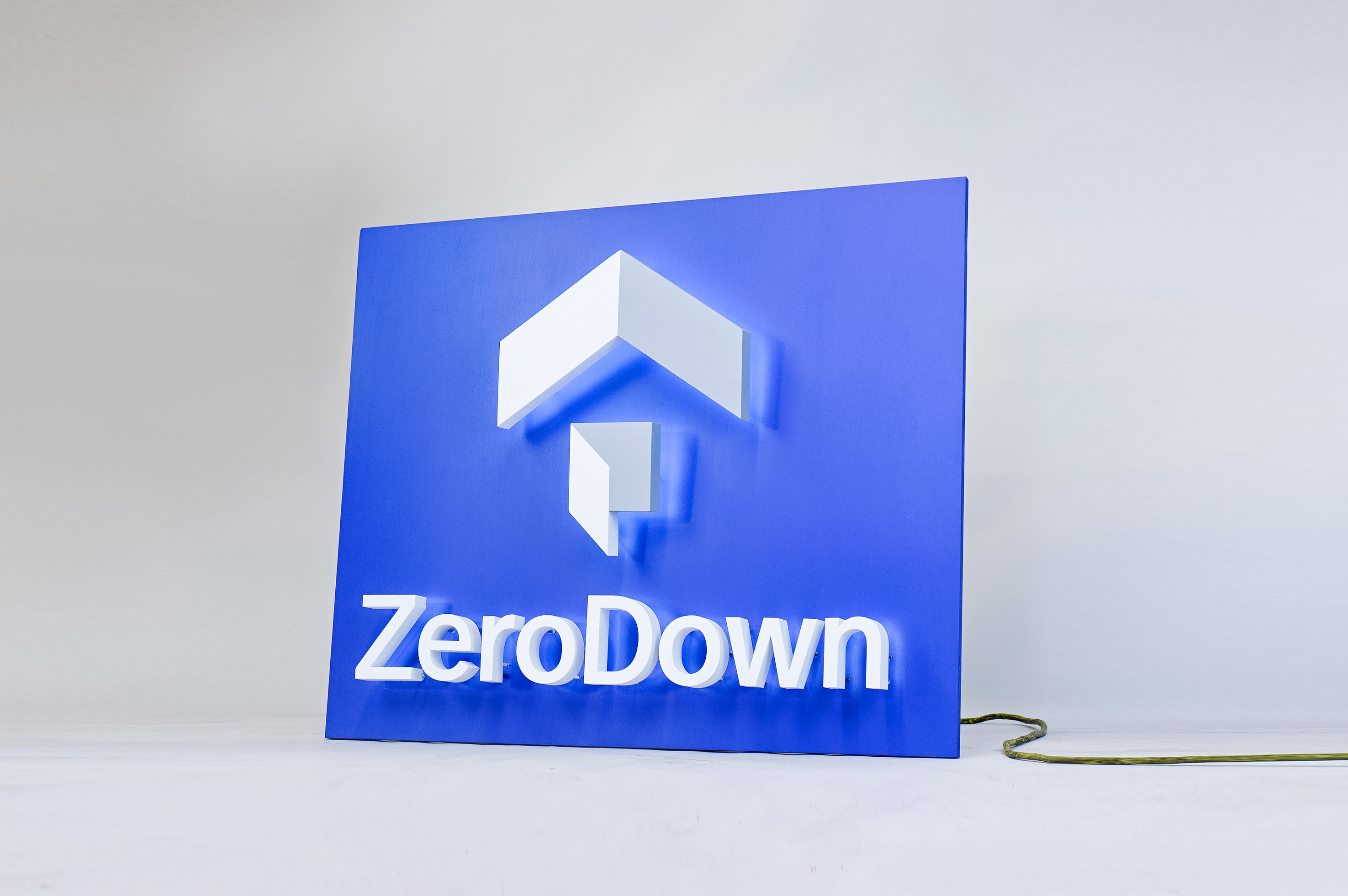 Back-lit, illuminated blue and white lobby sign for Zerodown, a company that couples technology and a debt-fueled real estate fund to allow home-buyers to forgo the traditional down payment process required to purchase a home.