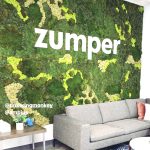 White letters on moss art wall for the lobby of Zumper, a full-service rental platform.