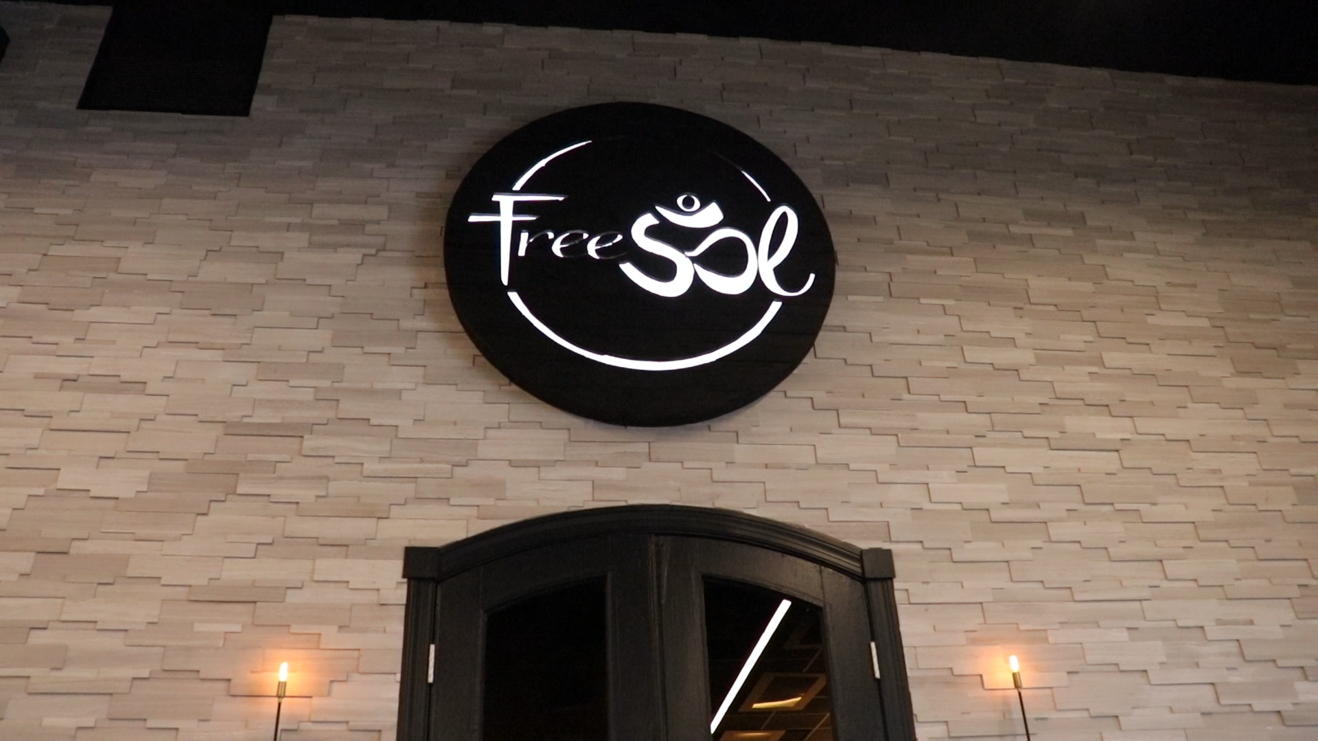 Torched wood, interior-lit, large circular wall sign for FreeSol, a fitness studio located in Styles Studios, a boutique fitness studio in Peoria, IL. Torched wood, interior-lit, large circular wall sign for FreeSol, a fitness studio located in Styles Studios, a boutique fitness studio in Peoria, IL.