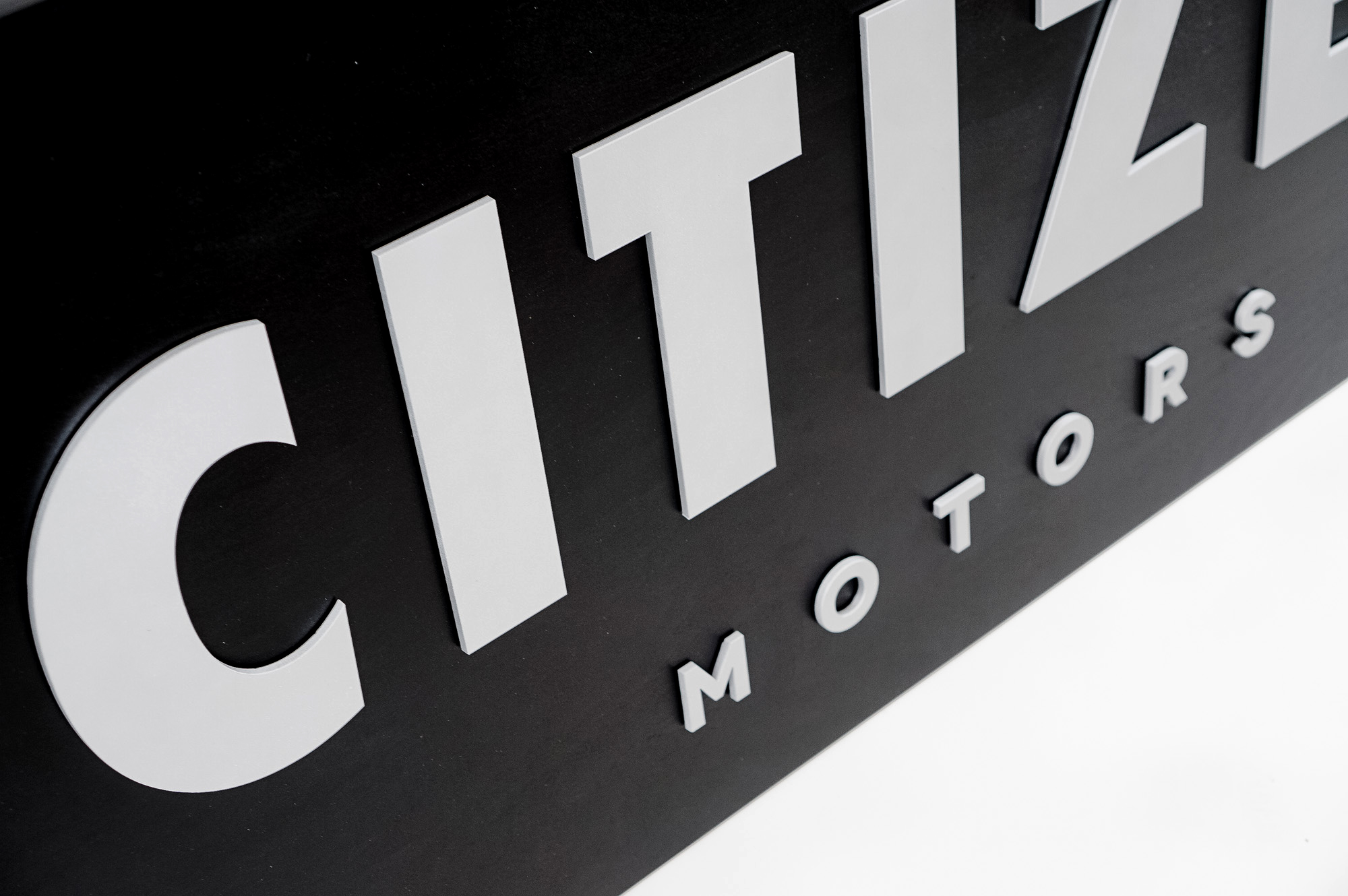Black sign with silver letters for Citizen Motors, a shop that builds and restores classic vehicles in the San Francisco Bay Area. Black sign with silver letters for Citizen Motors, a shop that builds and restores classic vehicles in the San Francisco Bay Area.
