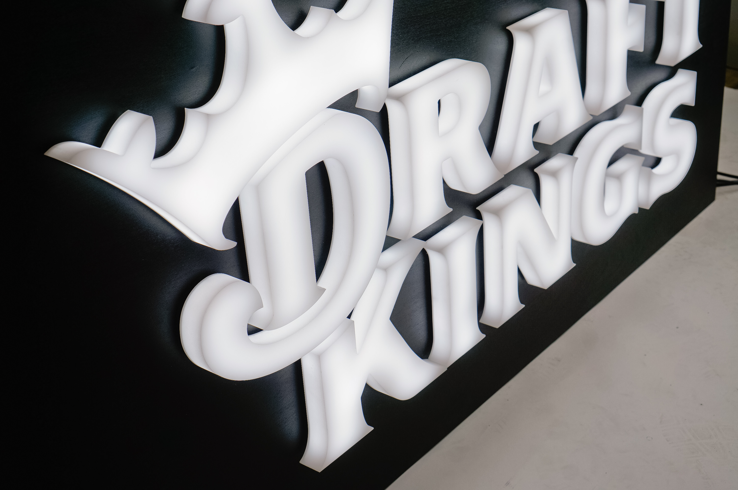 Illuminated, face-lit white logo on a black painted backer/wall for the San Francisco office of Draft Kings, an American daily fantasy sports contest and sports betting provider. Illuminated, face-lit white logo on a black painted backer/wall for the San Francisco office of Draft Kings, an American daily fantasy sports contest and sports betting provider.