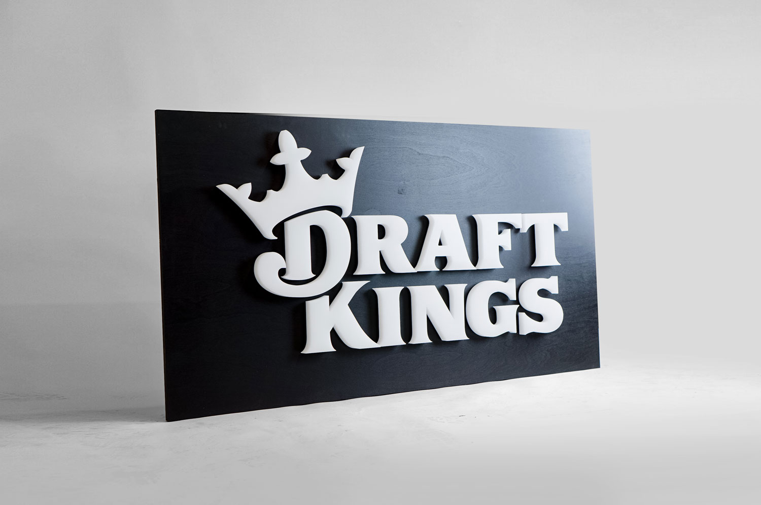 Illuminated, face-lit white logo on a black painted backer/wall for the San Francisco office of Draft Kings, an American daily fantasy sports contest and sports betting provider. Illuminated, face-lit white logo on a black painted backer/wall for the San Francisco office of Draft Kings, an American daily fantasy sports contest and sports betting provider.