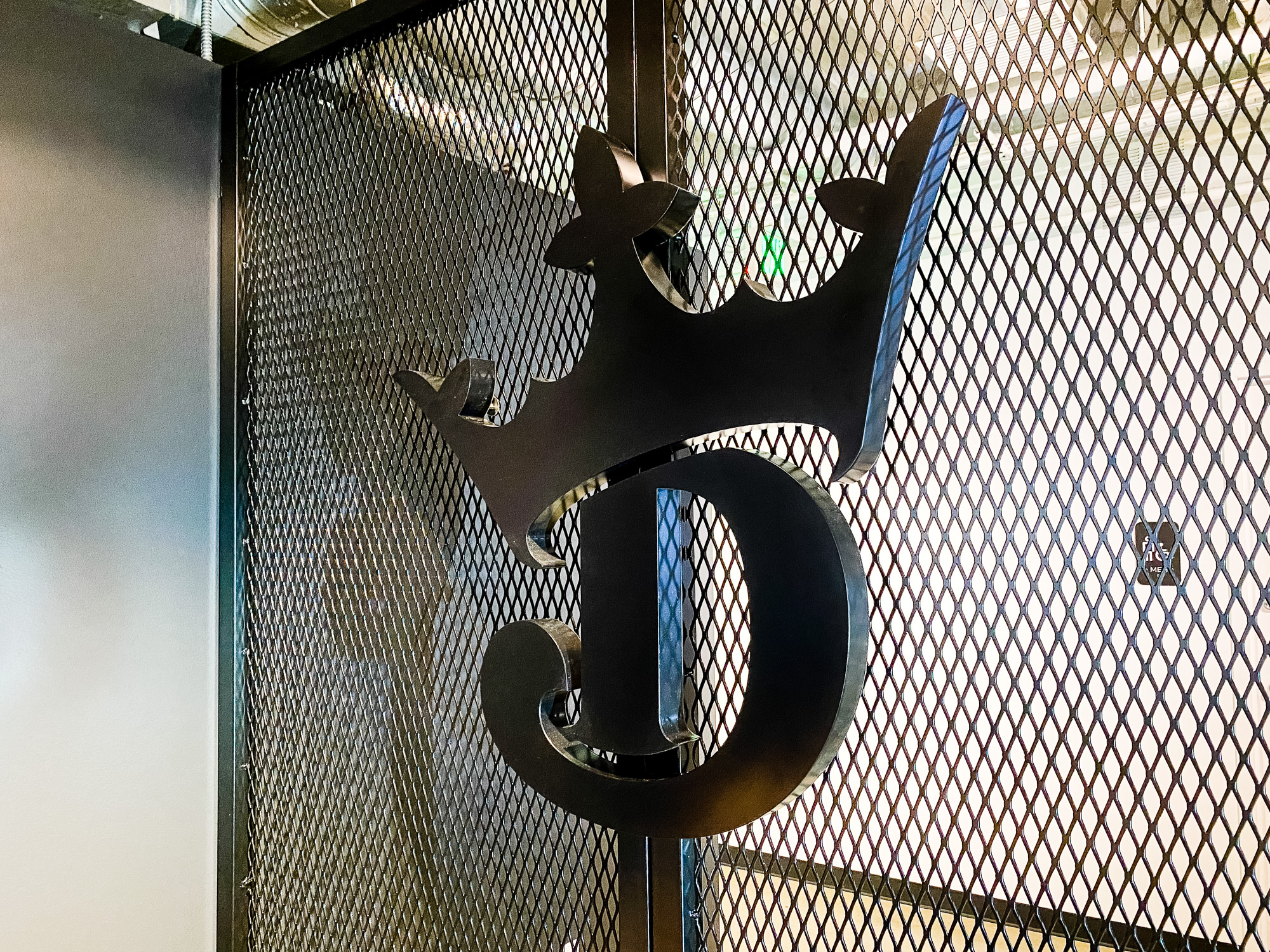 Mesh dividing wall with logo behind receptionist desk at the lobby of Draft Kings, an American daily fantasy sports contest and sports betting provider. Mesh dividing wall with logo behind receptionist desk at the lobby of Draft Kings, an American daily fantasy sports contest and sports betting provider.