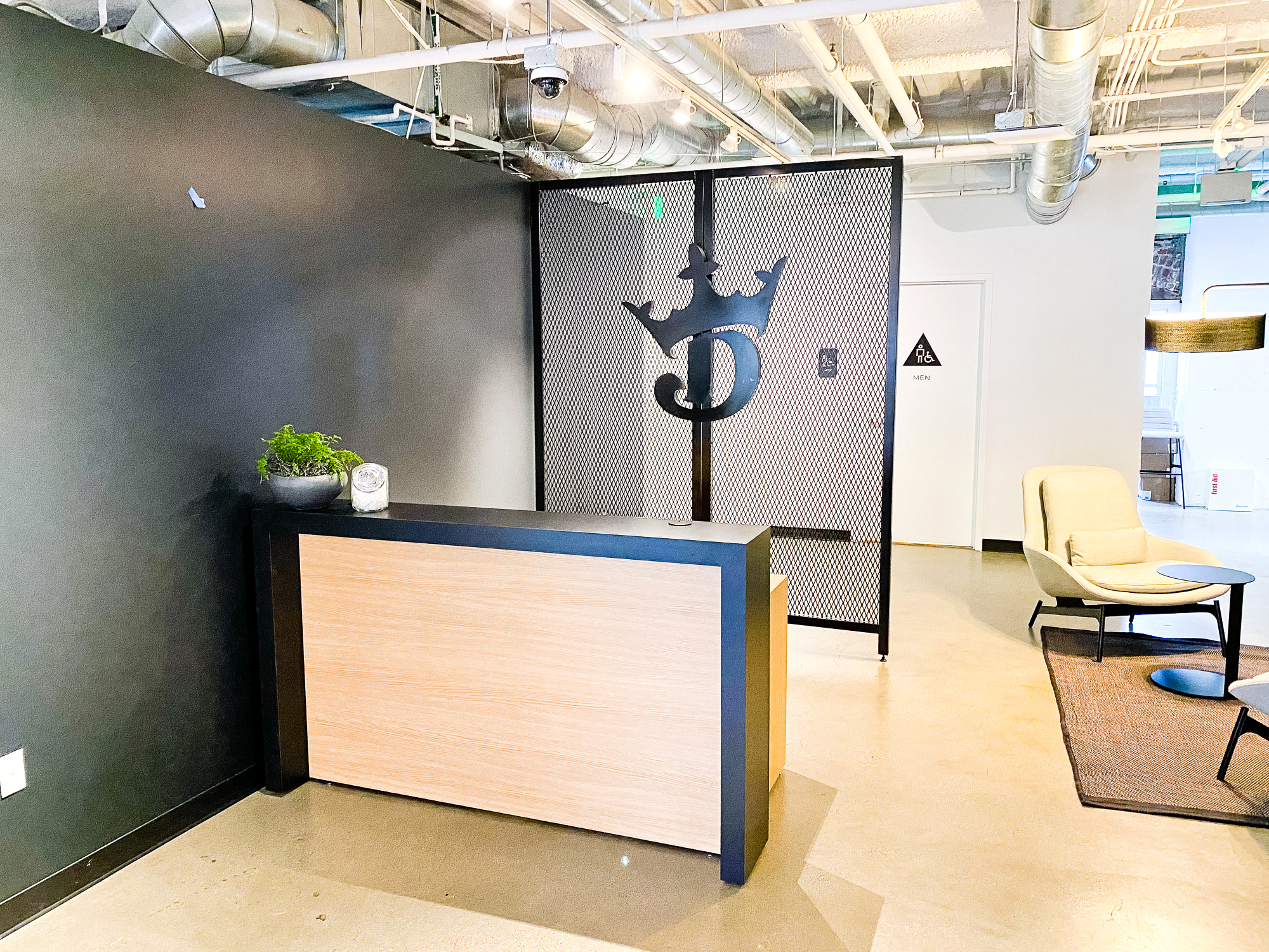 Mesh dividing wall with logo behind receptionist desk at the lobby of Draft Kings, an American daily fantasy sports contest and sports betting provider. Mesh dividing wall with logo behind receptionist desk at the lobby of Draft Kings, an American daily fantasy sports contest and sports betting provider.