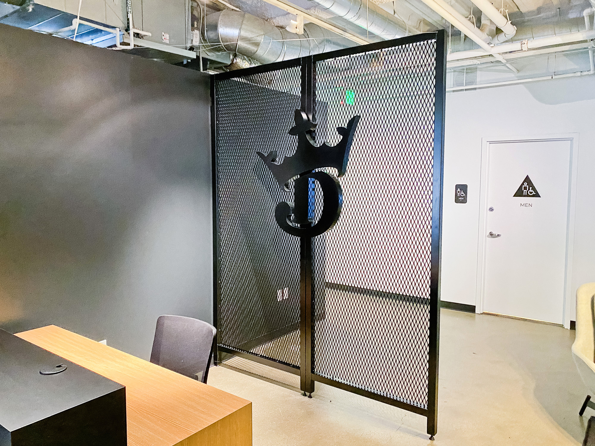Mesh dividing wall with logo behind receptionist desk at the lobby of Draft Kings, an American daily fantasy sports contest and sports betting provider. Mesh dividing wall with logo behind receptionist desk at the lobby of Draft Kings, an American daily fantasy sports contest and sports betting provider.
