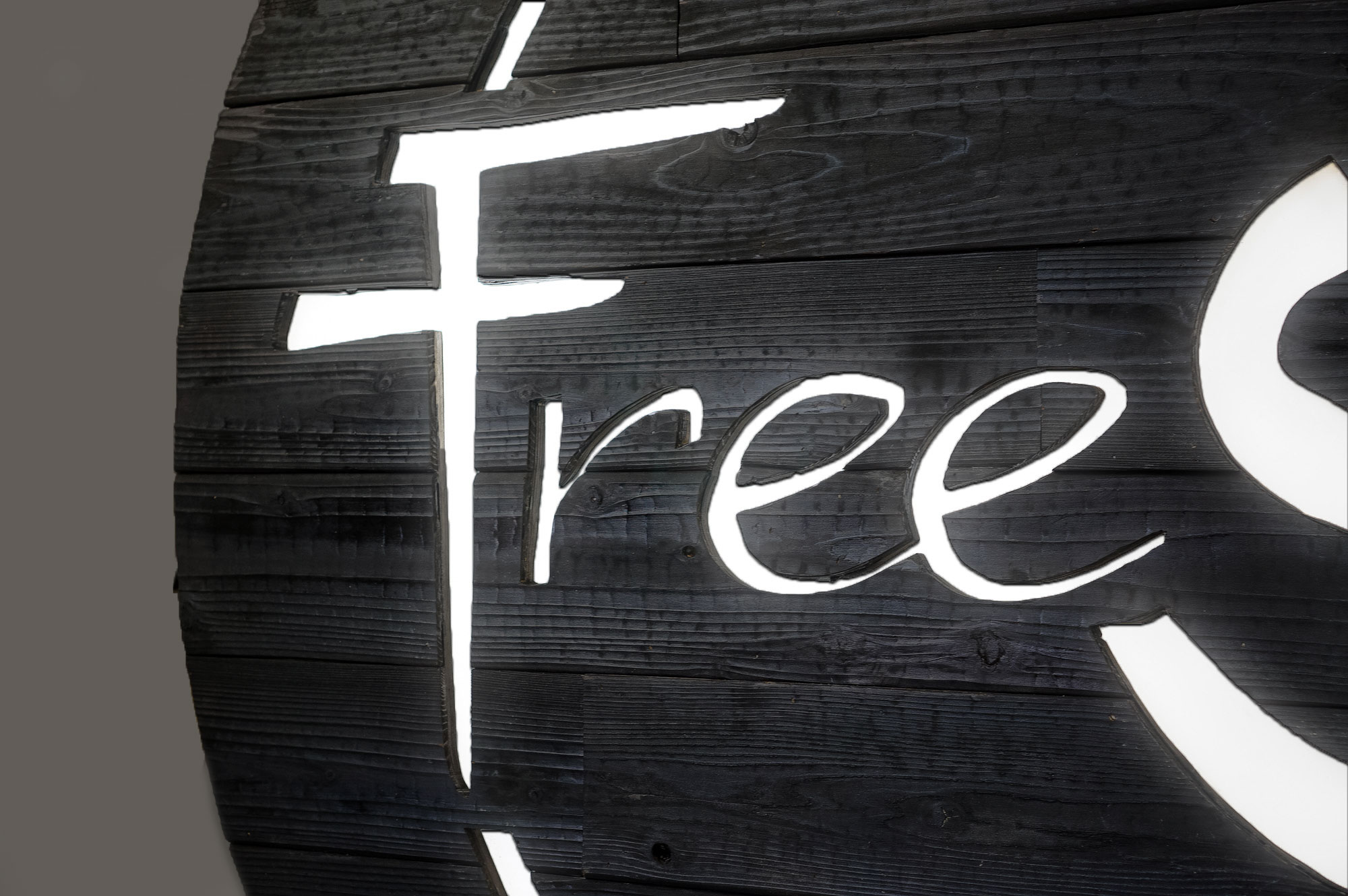 Torched wood, interior-lit, large circular wall sign for FreeSol, a fitness studio located in Styles Studios, a boutique fitness studio in Peoria, IL. Torched wood, interior-lit, large circular wall sign for FreeSol, a fitness studio located in Styles Studios, a boutique fitness studio in Peoria, IL.
