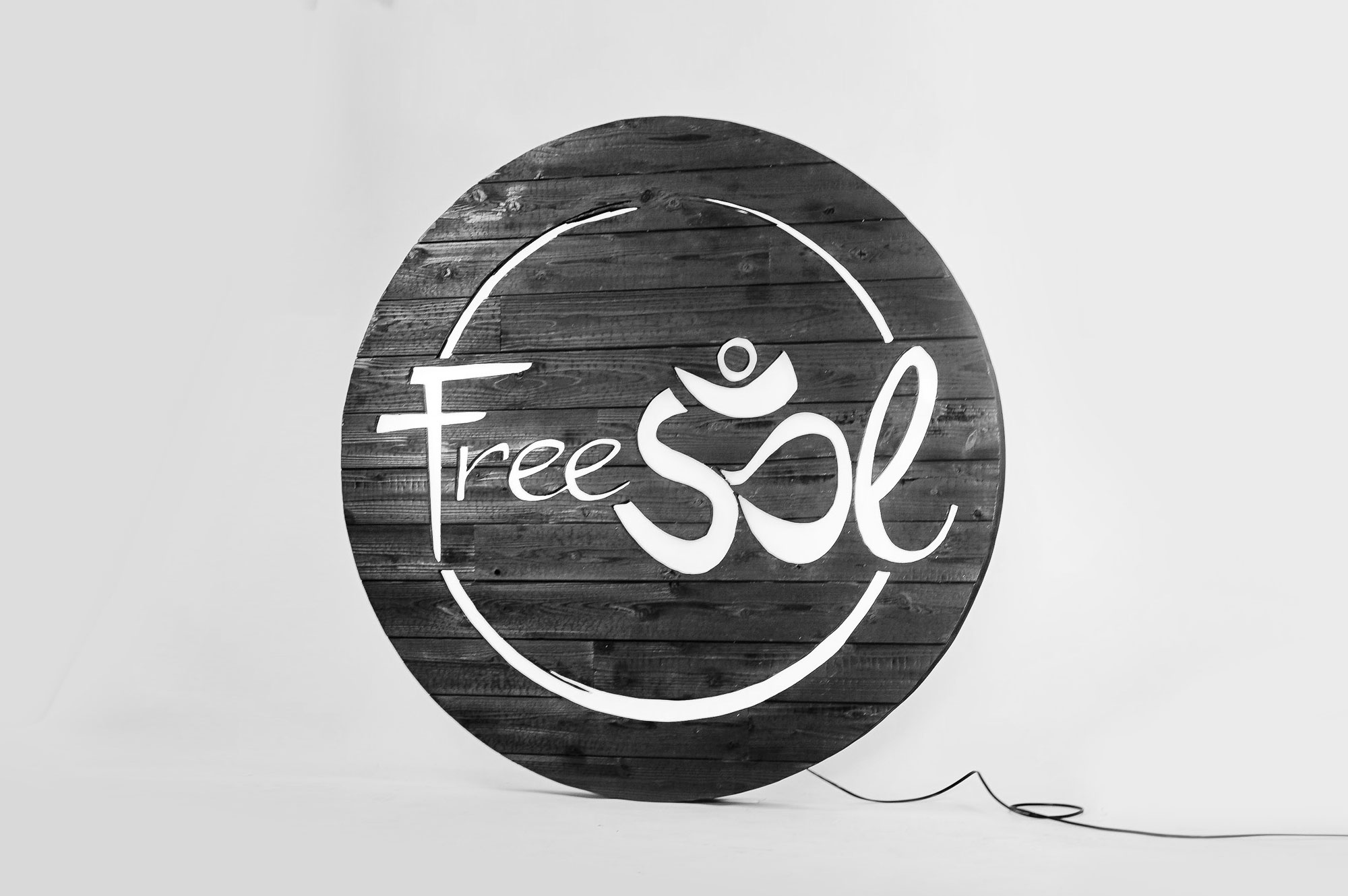 Torched wood, interior-lit, large circular wall sign for FreeSol, a fitness studio located in Styles Studios, a boutique fitness studio in Peoria, IL. Torched wood, interior-lit, large circular wall sign for FreeSol, a fitness studio located in Styles Studios, a boutique fitness studio in Peoria, IL.