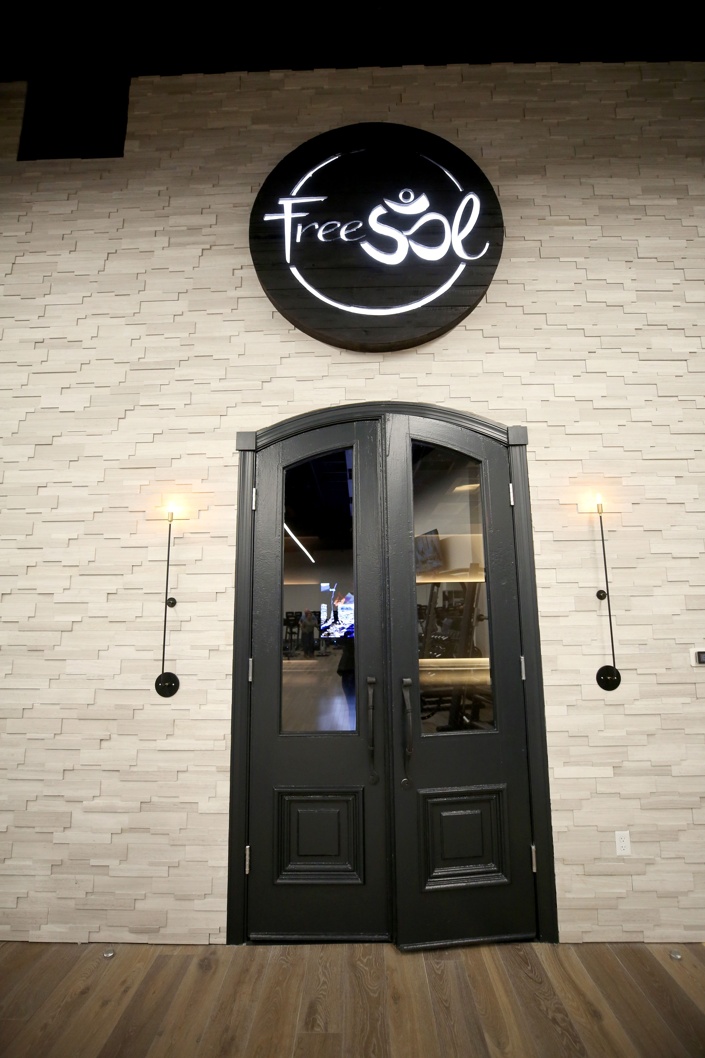 Torched wood, interior-lit, large circular wall sign for FreeSol, a fitness studio located in Styles Studios, a boutique fitness studio in Peoria, IL. Torched wood, interior-lit, large circular wall sign for FreeSol, a fitness studio located in Styles Studios, a boutique fitness studio in Peoria, IL.