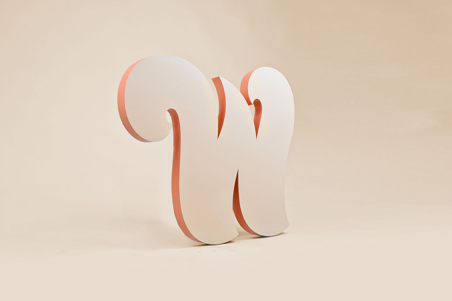“W” wing logo in tone-on-tone paint with contrasting edges for the lobby of the Williamsburg location of The Wing, a co-working space for women.