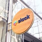 Wood blade sign with dimensional color logo and brass hardware for the San Francisco brand space at Slack, an American cloud-based set of team collaboration tools and services.