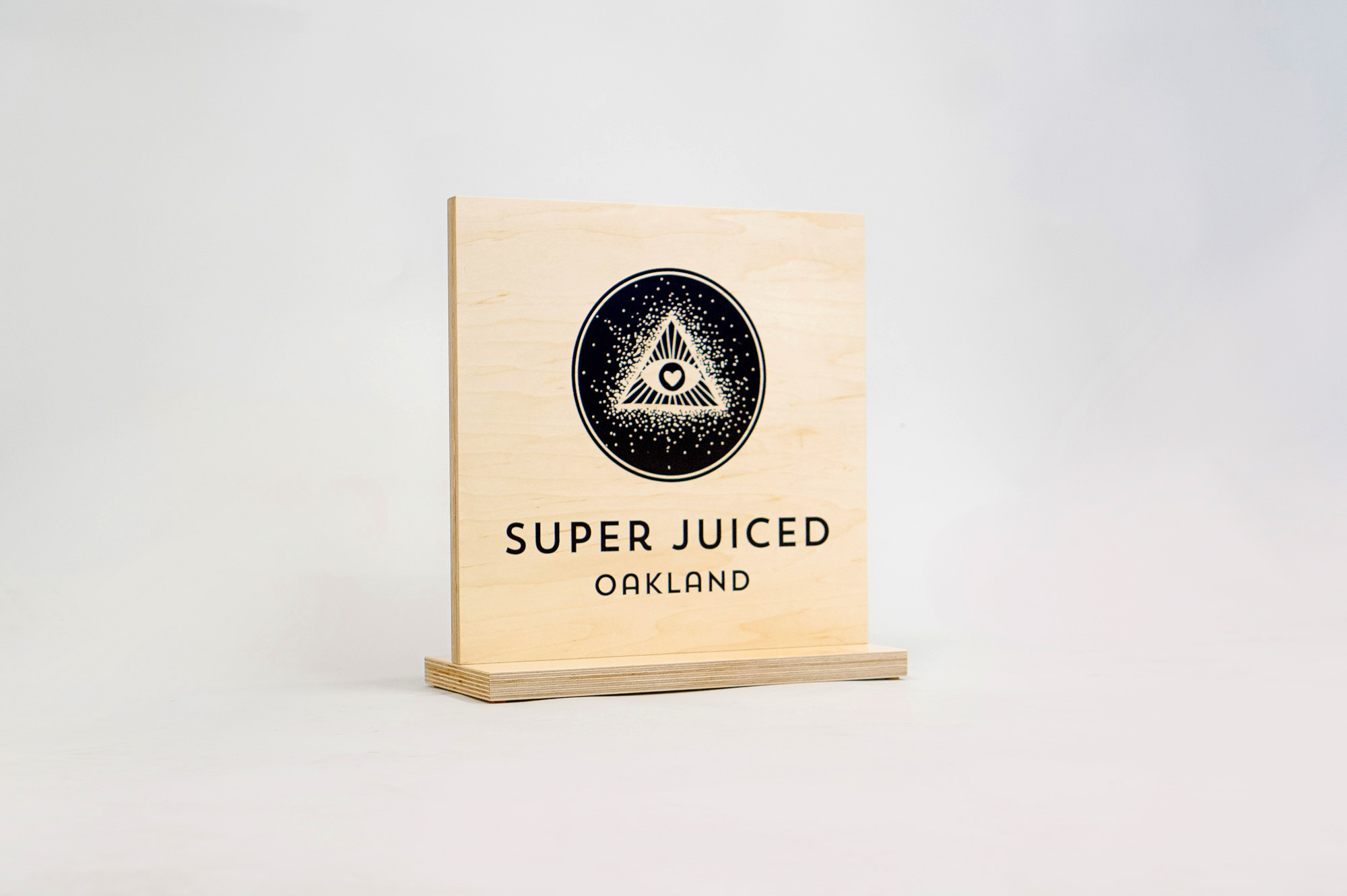 Light wood tabletop sign with black print for the retail location of Super Juiced, an organic juice and smoothie bar in Old Oakland. Light wood tabletop sign with black print for the retail location of Super Juiced, an organic juice and smoothie bar in Old Oakland.