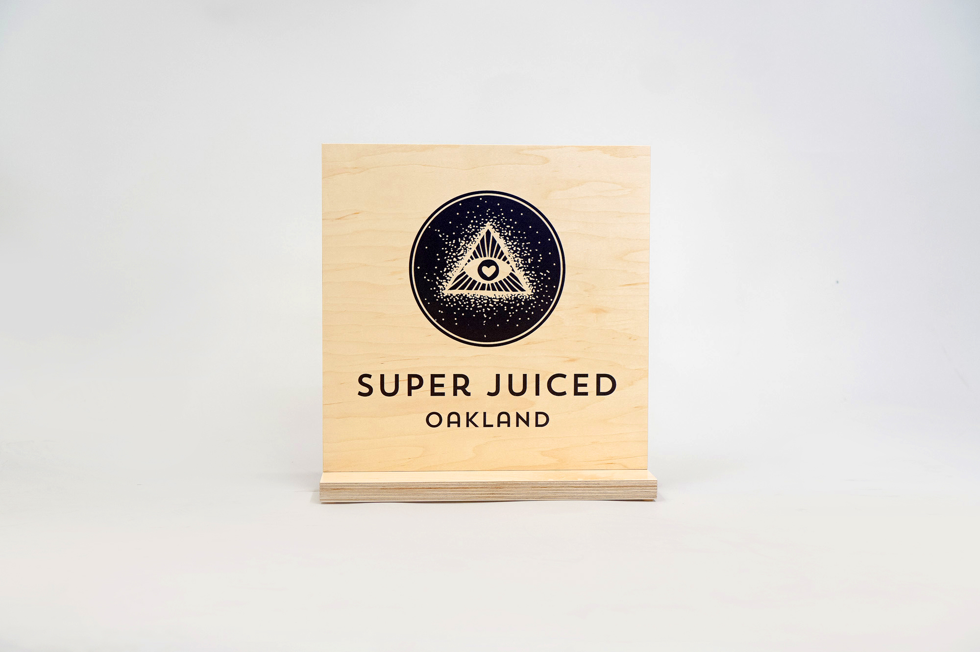 Light wood tabletop sign with black print for the retail location of Super Juiced, an organic juice and smoothie bar in Old Oakland. Light wood tabletop sign with black print for the retail location of Super Juiced, an organic juice and smoothie bar in Old Oakland.