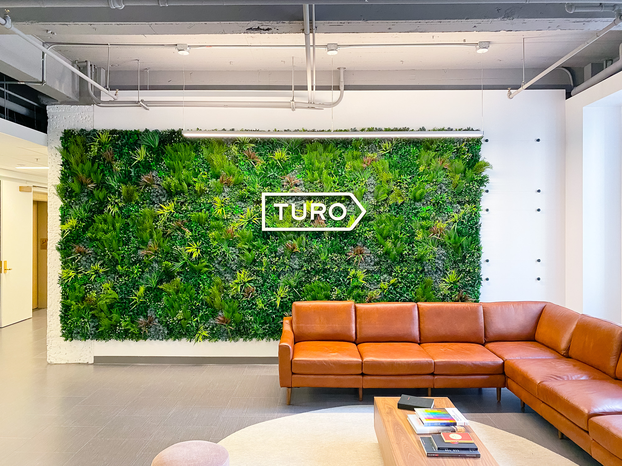White dimensional logo on Vistagreen living wall for the lobby of Turo, an American peer-to-peer carsharing company.