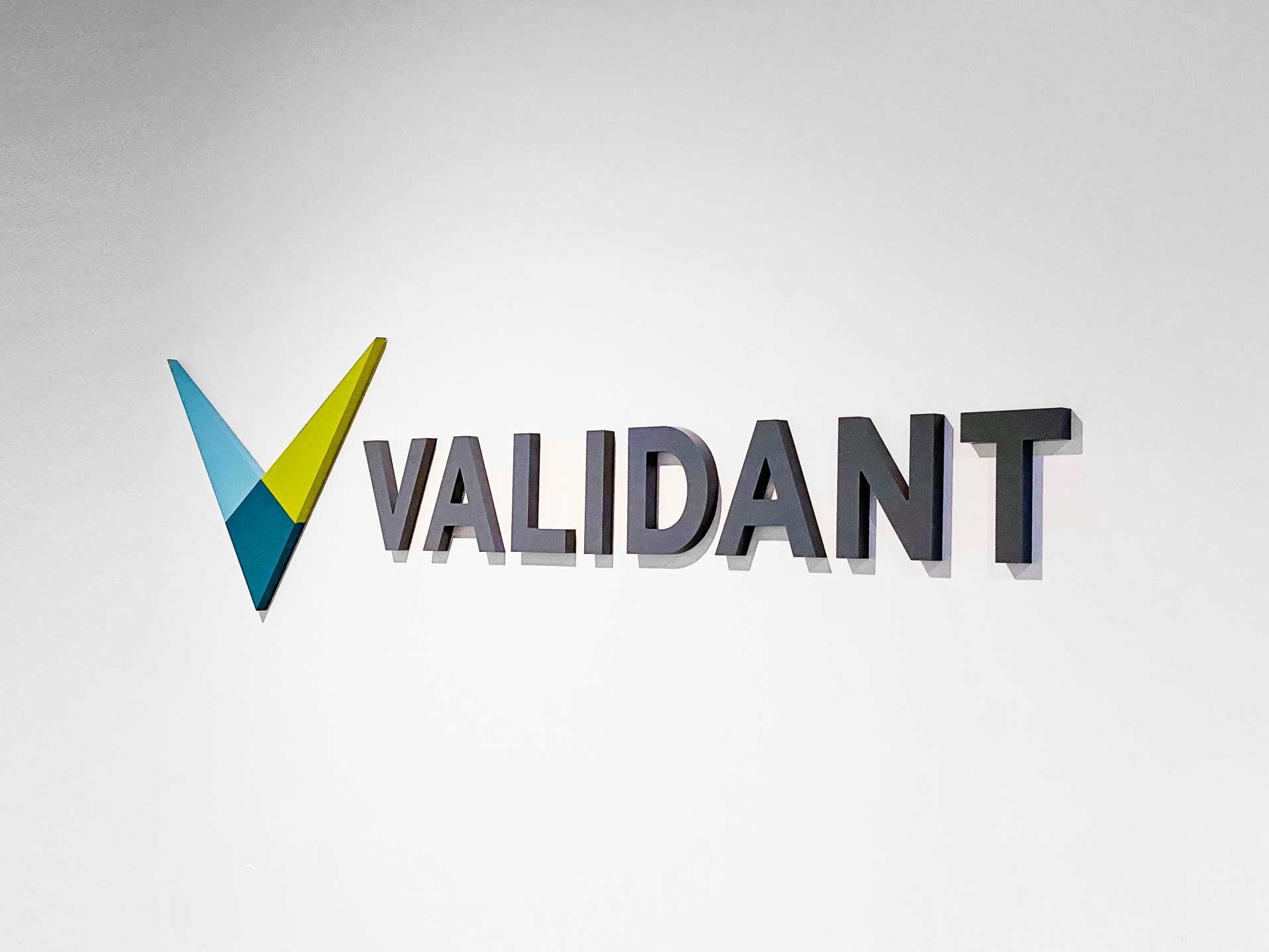 Full color dimensional logo on white wall for the lobby of Validant, a San Francisco based company that delivers end-to-end quality, compliance, and regulatory consulting service for healthcare companies around the world. Full color dimensional logo on white wall for the lobby of Validant, a San Francisco based company that delivers end-to-end quality, compliance, and regulatory consulting service for healthcare companies around the world.