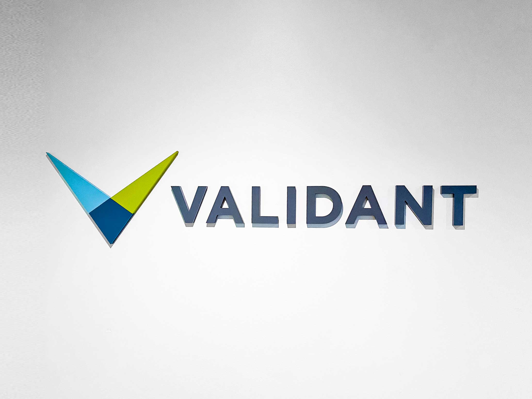 Full color dimensional logo on white wall for the lobby of Validant, a San Francisco based company that delivers end-to-end quality, compliance, and regulatory consulting service for healthcare companies around the world. Full color dimensional logo on white wall for the lobby of Validant, a San Francisco based company that delivers end-to-end quality, compliance, and regulatory consulting service for healthcare companies around the world.