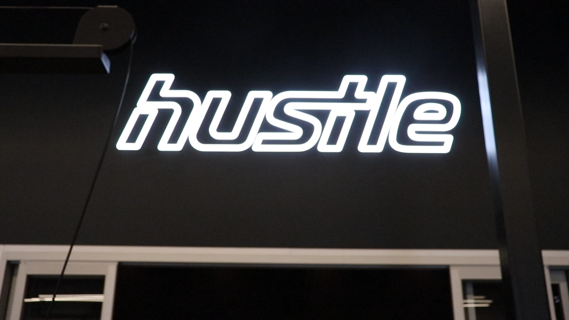 Neon style sign for Hustle, a strength and cardio studio inside Styles Studios, a fitness club in Peoria, IL. Neon style sign for Hustle, a strength and cardio studio inside Styles Studios, a fitness club in Peoria, IL.