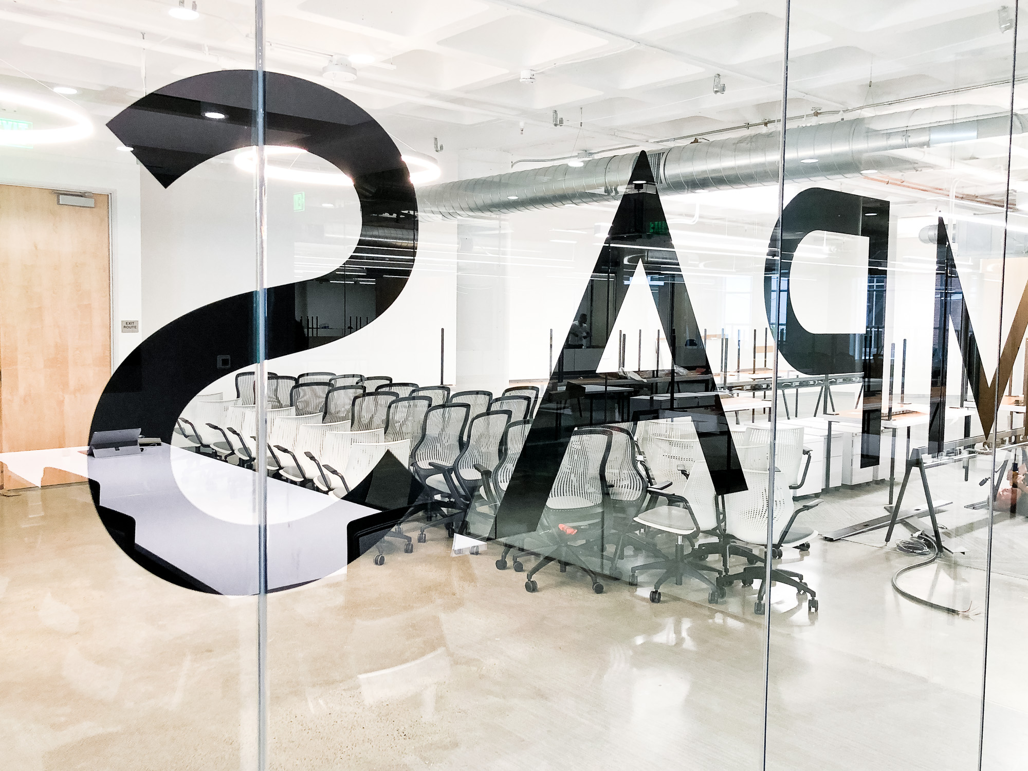 Glass vinyl sign / privacy screen at the San Francisco office of Compass, a modern real estate platform. Glass vinyl sign / privacy screen at the San Francisco office of Compass, a modern real estate platform.