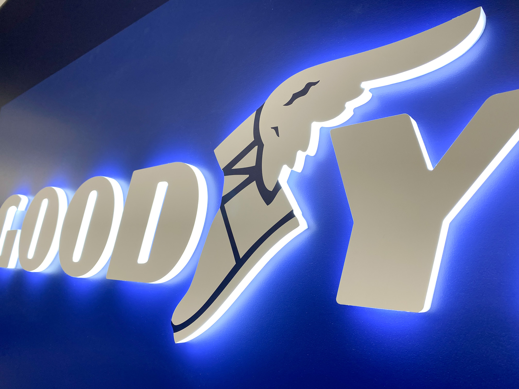 Illuminated, blue, edge-lit lobby sign behind reception desk for the San Francisco office of Goodyear, a tire manufacturer. Illuminated, blue, edge-lit lobby sign behind reception desk for the San Francisco office of Goodyear, a tire manufacturer.