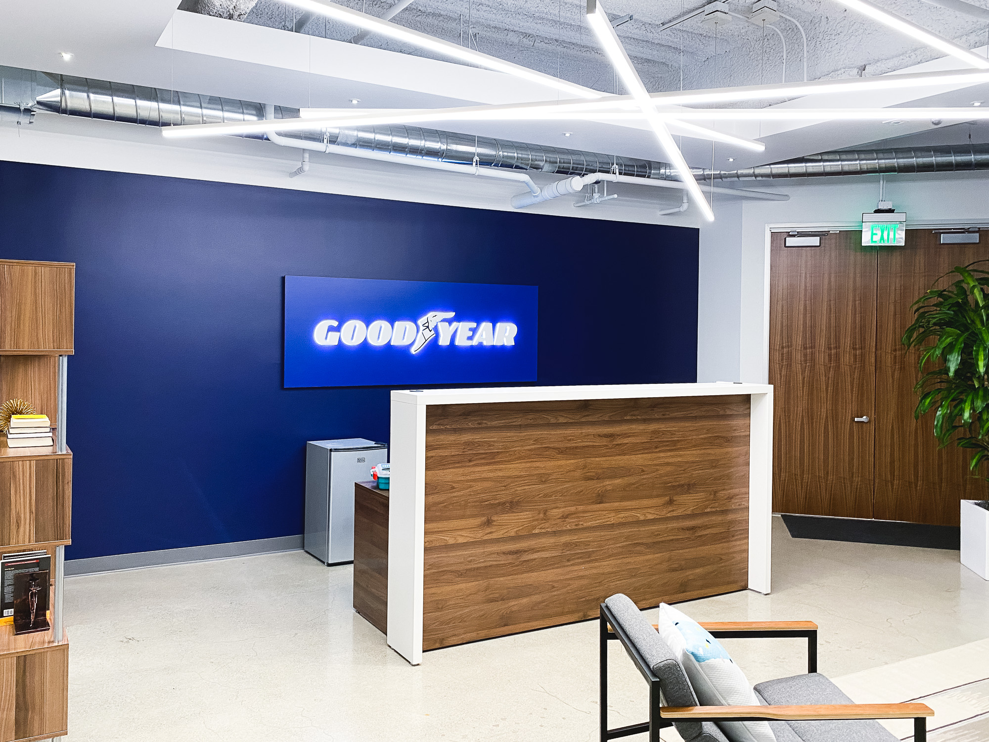 Illuminated, blue, edge-lit lobby sign behind reception desk for the San Francisco office of Goodyear, a tire manufacturer. Illuminated, blue, edge-lit lobby sign behind reception desk for the San Francisco office of Goodyear, a tire manufacturer.