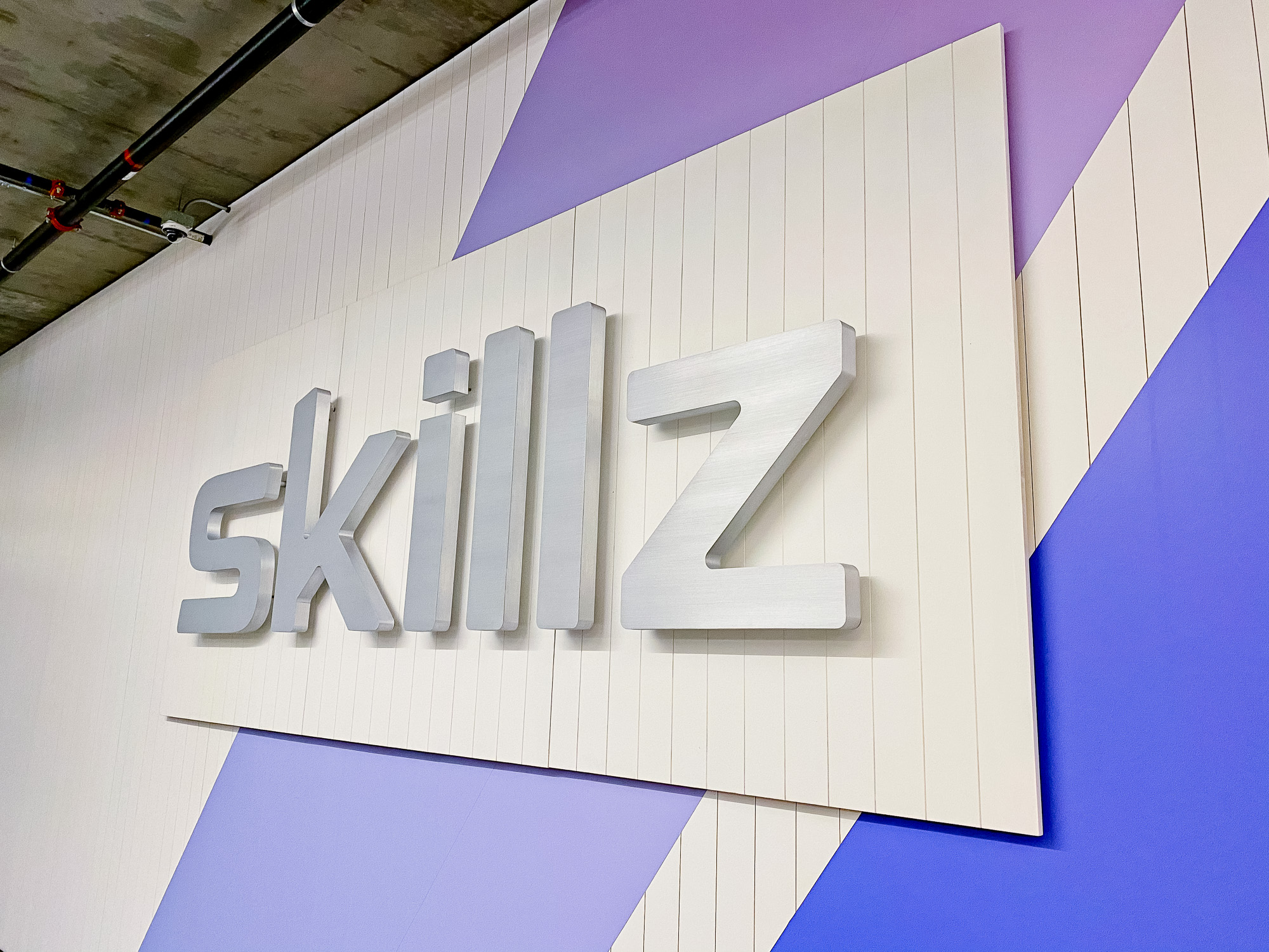 Illuminated metal sign for the reception desk at the San Francisco office of Skillz, an online mobile multiplayer competition platform.
