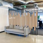 Custom slat wood and metal divider wall for the San Francisco office of Asana, a web and mobile application designed to help teams organize, track, and manage their work.