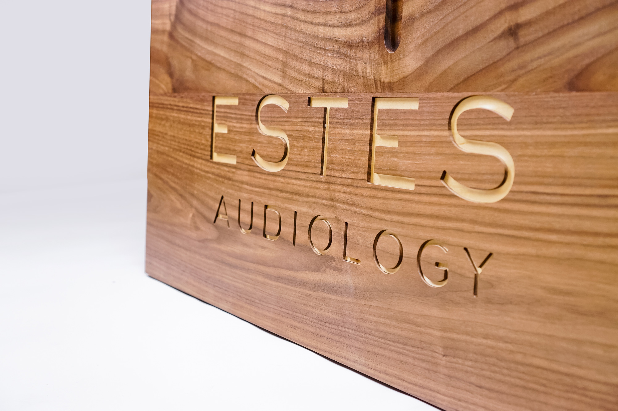 Solid walnut sign with engraved and inlaid logo for Estes Audiology, one of the largest independent hearing device practices in the Texas Hill Country. Solid walnut sign with engraved and inlaid logo for Estes Audiology, one of the largest independent hearing device practices in the Texas Hill Country.