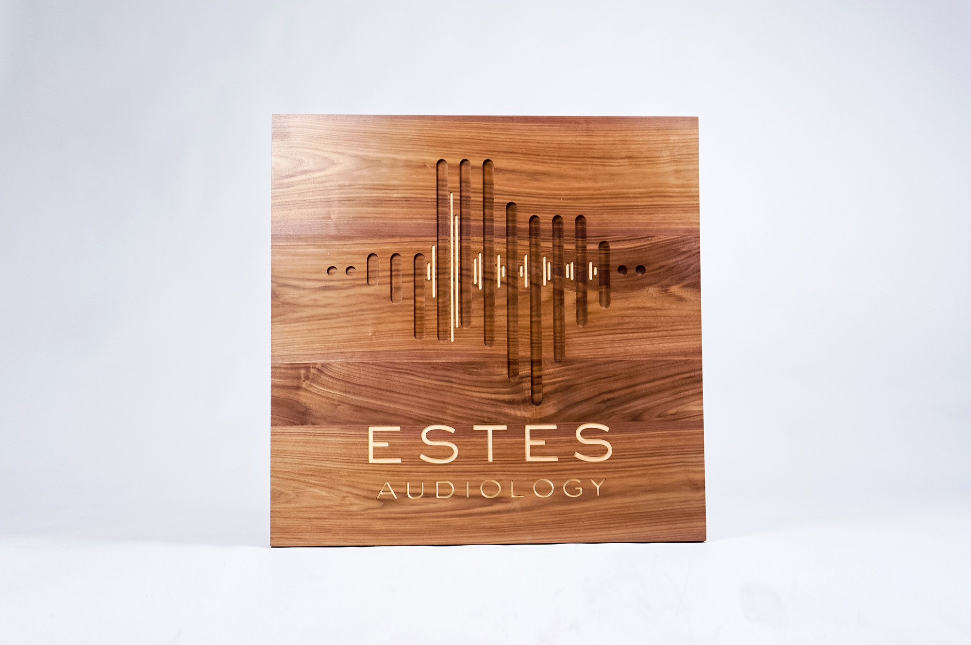 Solid walnut sign with engraved and inlaid logo for Estes Audiology, one of the largest independent hearing device practices in the Texas Hill Country. Solid walnut sign with engraved and inlaid logo for Estes Audiology, one of the largest independent hearing device practices in the Texas Hill Country.