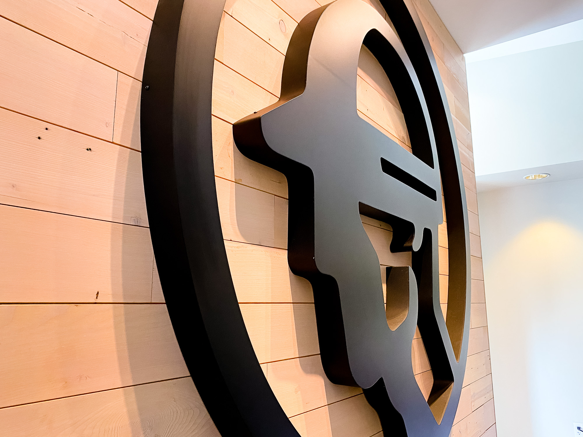 Dimensional black reception wall and desk sign for the San Francisco lobby of Fieldwire, a company creating a construction field management platform designed for the jobsite.