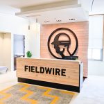 Dimensional black reception wall and desk sign for the San Francisco lobby of Fieldwire, a company creating a construction field management platform designed for the jobsite.