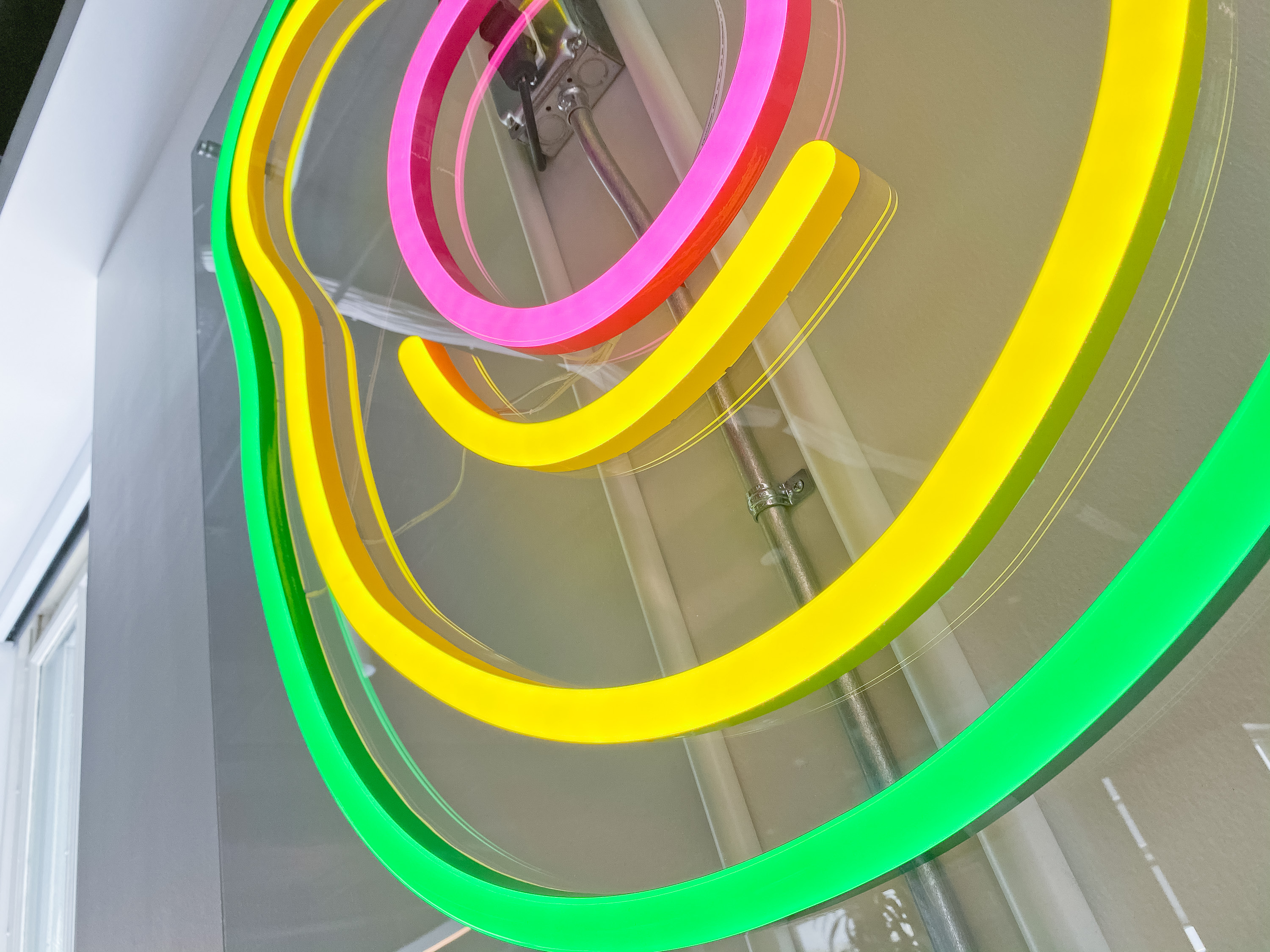 Neon avocado sign with clear acrylic backer on white wall for the San Francisco office of Meltwater, a software as a service company that develops and markets media monitoring and business intelligence software. Neon avocado sign with clear acrylic backer on white wall for the San Francisco office of Meltwater, a software as a service company that develops and markets media monitoring and business intelligence software.