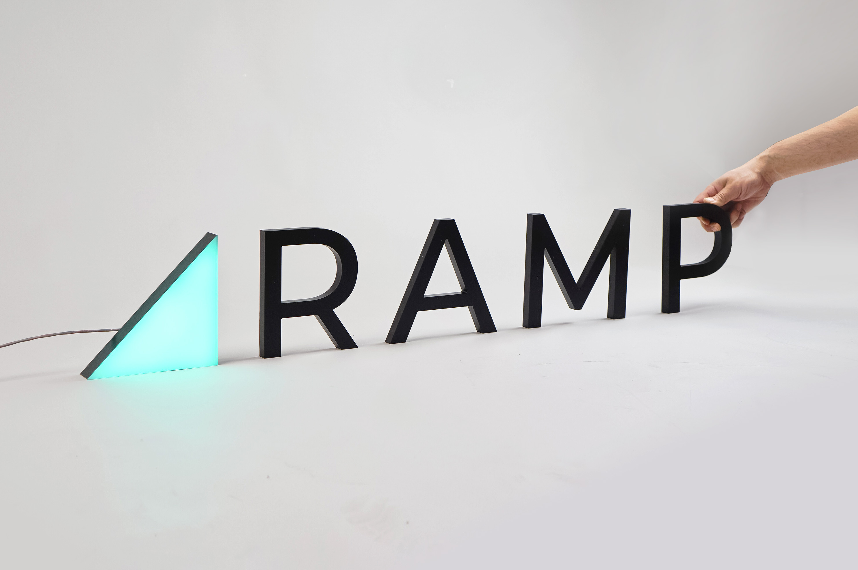 Illuminated, freestanding green triangle and black letters for Ramp, a technology company building the next generation corporate card to save businesses money. Illuminated, freestanding green triangle and black letters for Ramp, a technology company building the next generation corporate card to save businesses money.