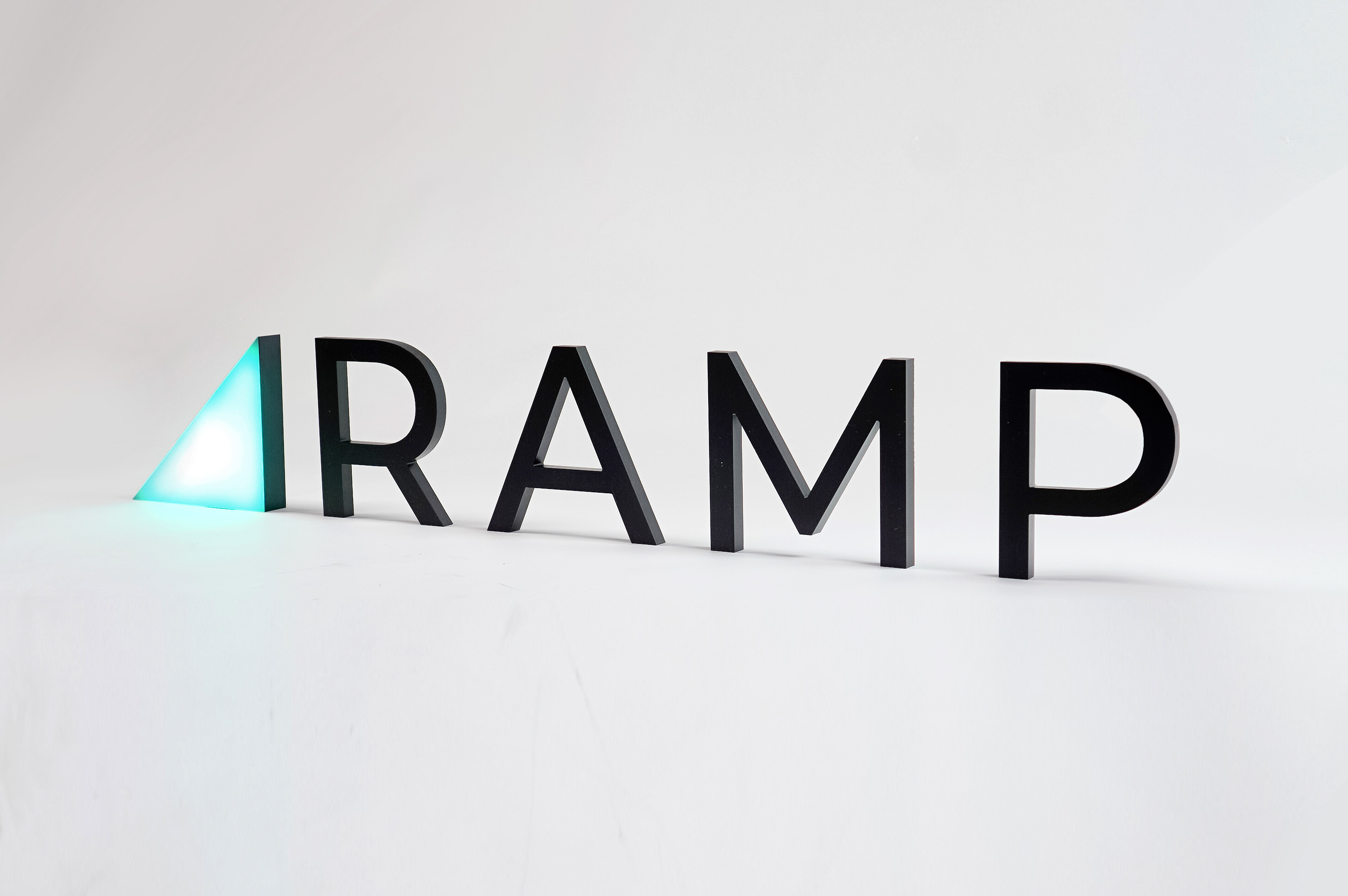 Illuminated, freestanding green triangle and black letters for Ramp, a technology company building the next generation corporate card to save businesses money. Illuminated, freestanding green triangle and black letters for Ramp, a technology company building the next generation corporate card to save businesses money.