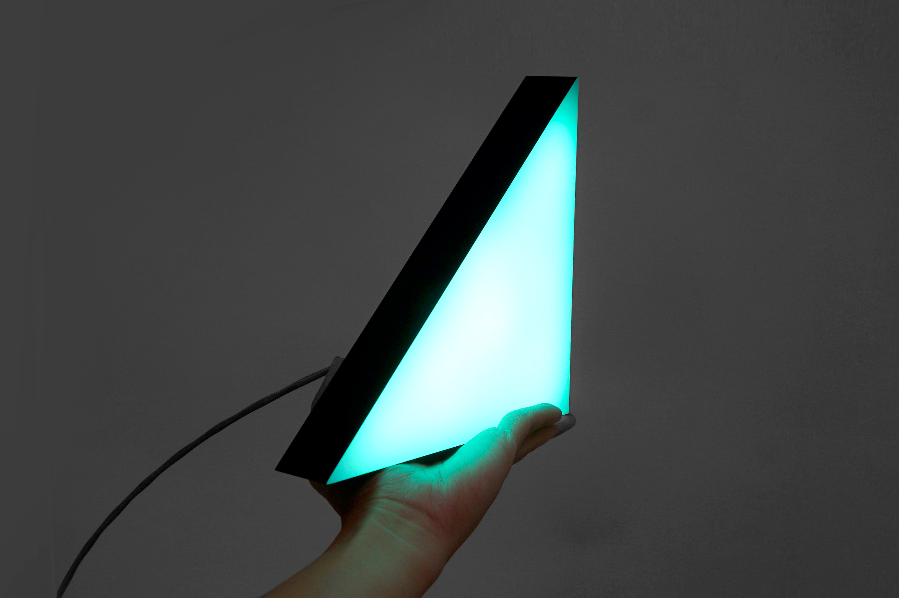 Illuminated, freestanding green triangle and black letters for Ramp, a technology company building the next generation corporate card to save businesses money.