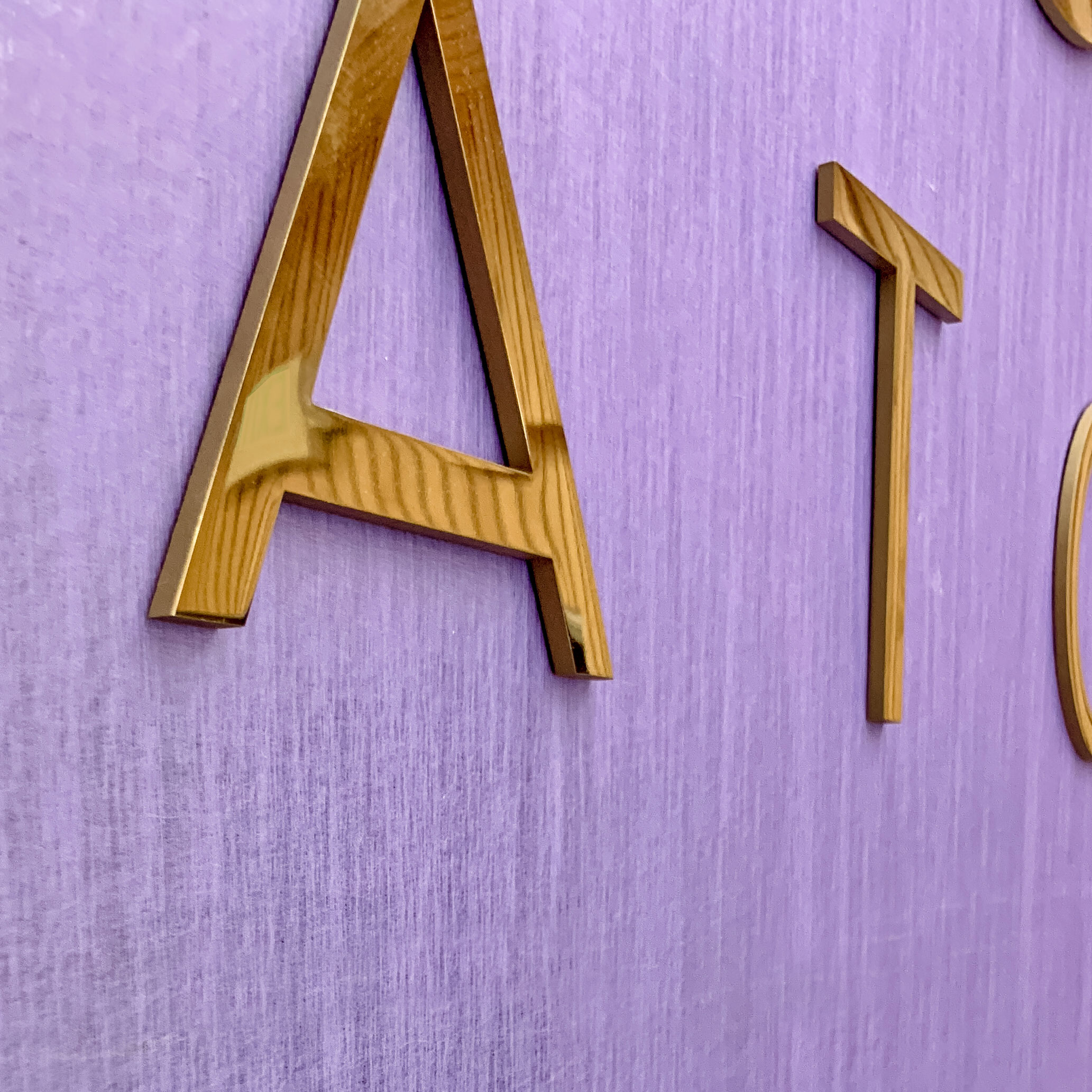 Solid polished brass sign on purple silk wall for the lobby at Tatcha, a company that creates luxury Japanese beauty products. Solid polished brass sign on purple silk wall for the lobby at Tatcha, a company that creates luxury Japanese beauty products.