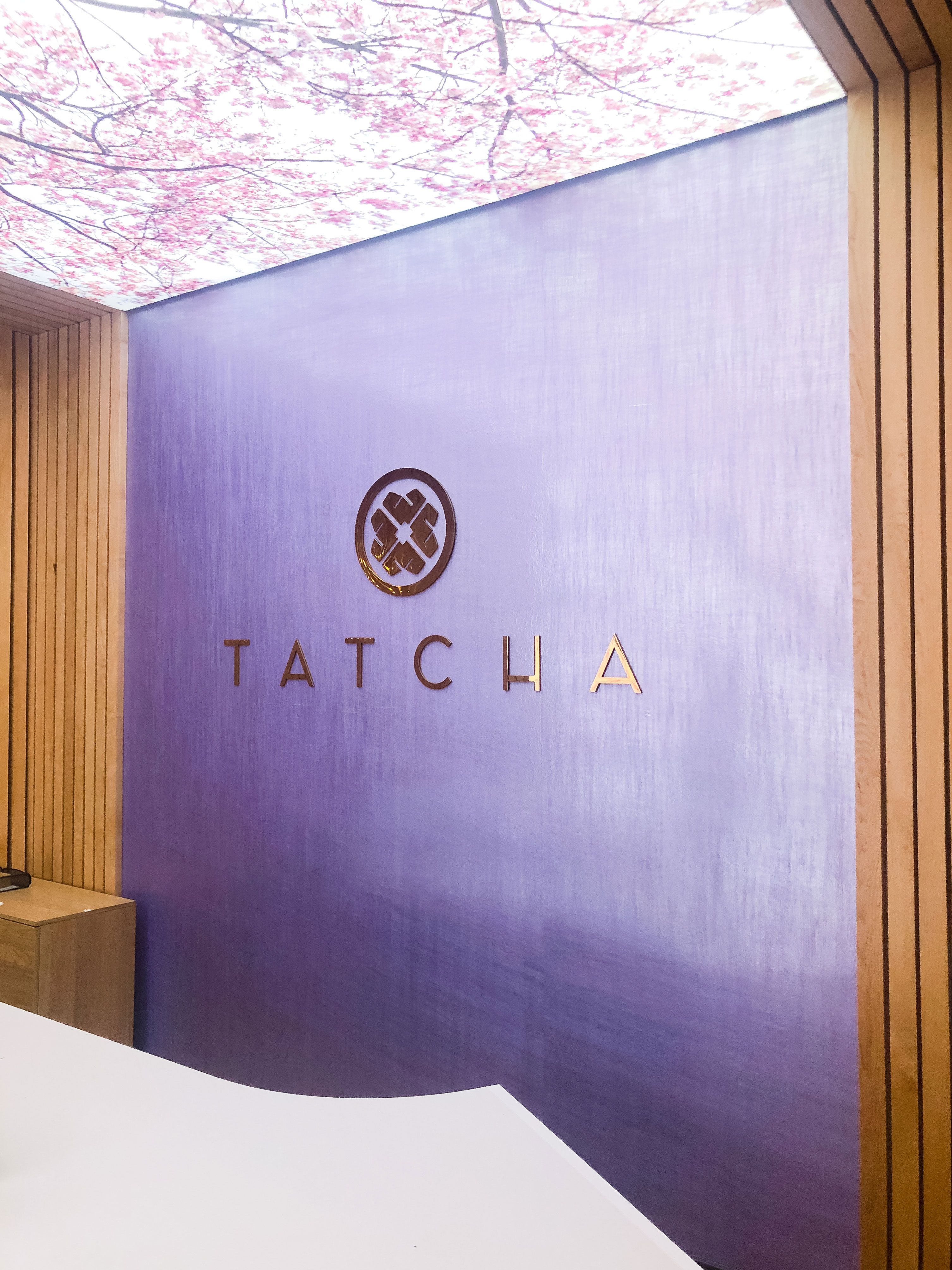 Solid polished brass sign on purple silk wall for the lobby at Tatcha, a company that creates luxury Japanese beauty products.