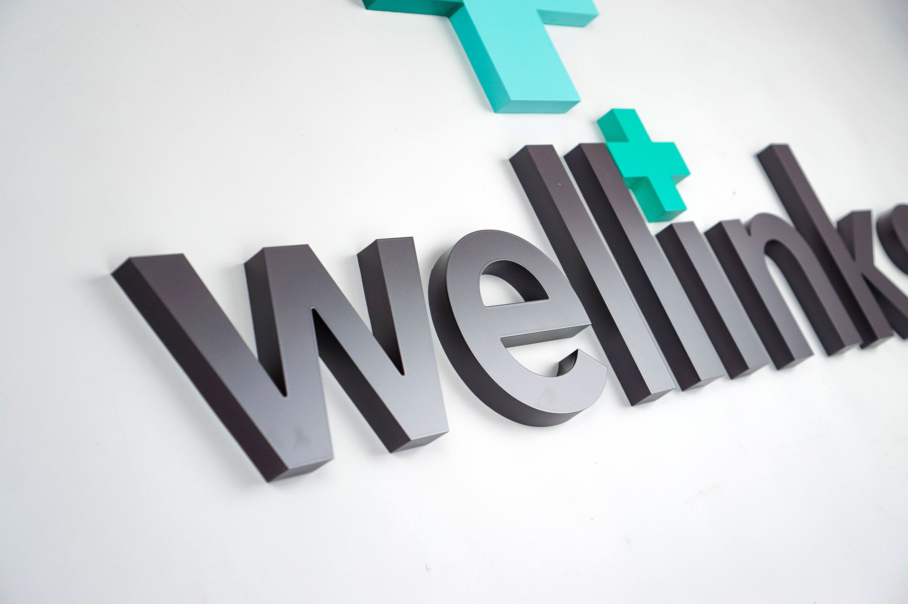 Green and grey lobby/reception logo sign for Wellinks, a wearable health technology company based in New Haven, Connecticut. Green and grey lobby/reception logo sign for Wellinks, a wearable health technology company based in New Haven, Connecticut.