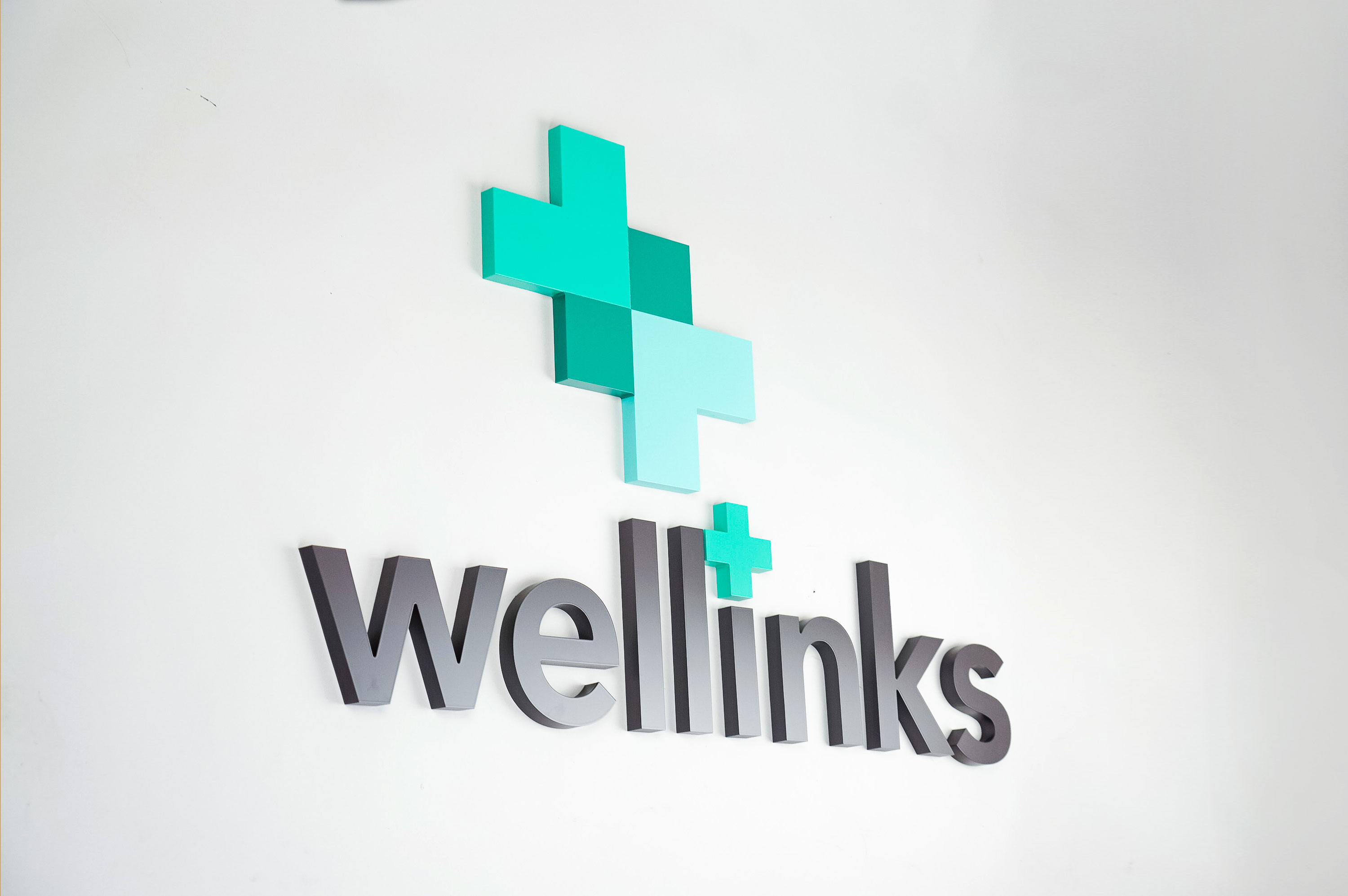 Green and grey lobby/reception logo sign for Wellinks, a wearable health technology company based in New Haven, Connecticut. Green and grey lobby/reception logo sign for Wellinks, a wearable health technology company based in New Haven, Connecticut.