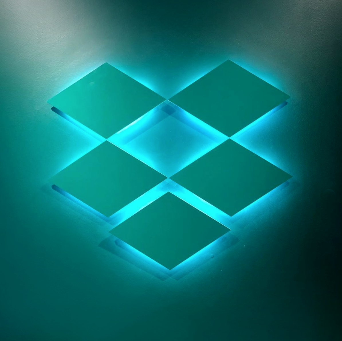 Teal, backlit, tone on tone wall sign for Dropbox, a file hosting service operated by Dropbox, Inc., headquartered in San Francisco, California.
