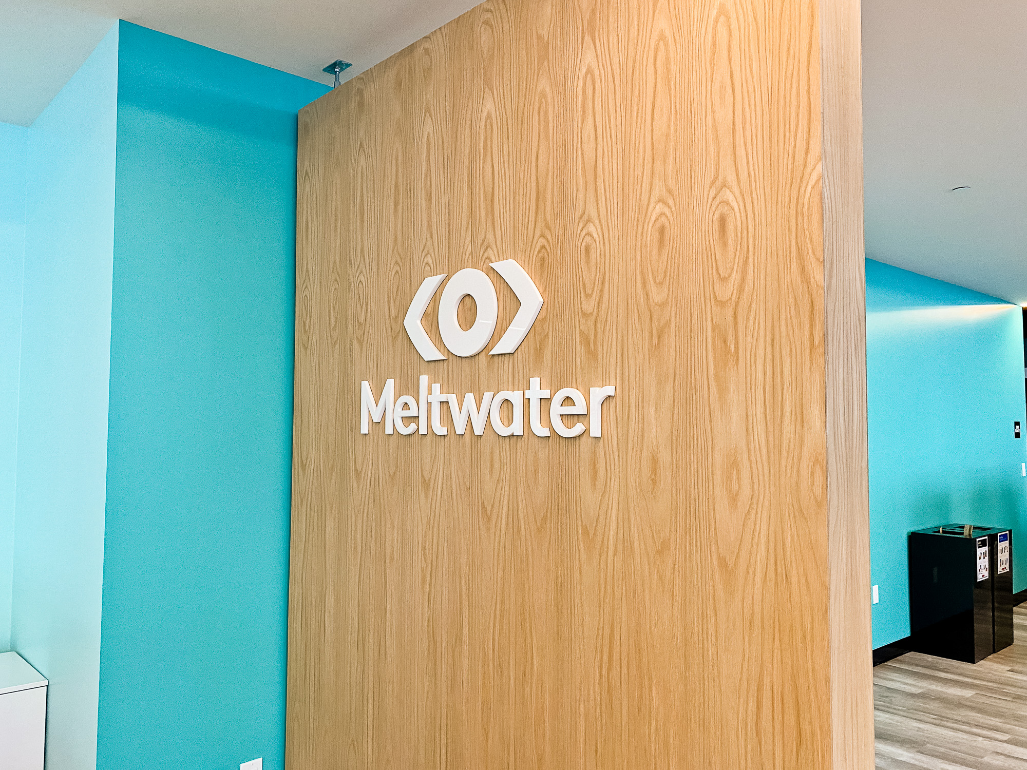 White logo on light wood add-on divider wall for the San Francisco office of Meltwater, a software as a service company that develops and markets media monitoring and business intelligence software. White logo on light wood add-on divider wall for the San Francisco office of Meltwater, a software as a service company that develops and markets media monitoring and business intelligence software.