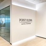 Simple black lobby sign on painted wall with uplights for the San Francisco office of Point Olema Capital Partners.