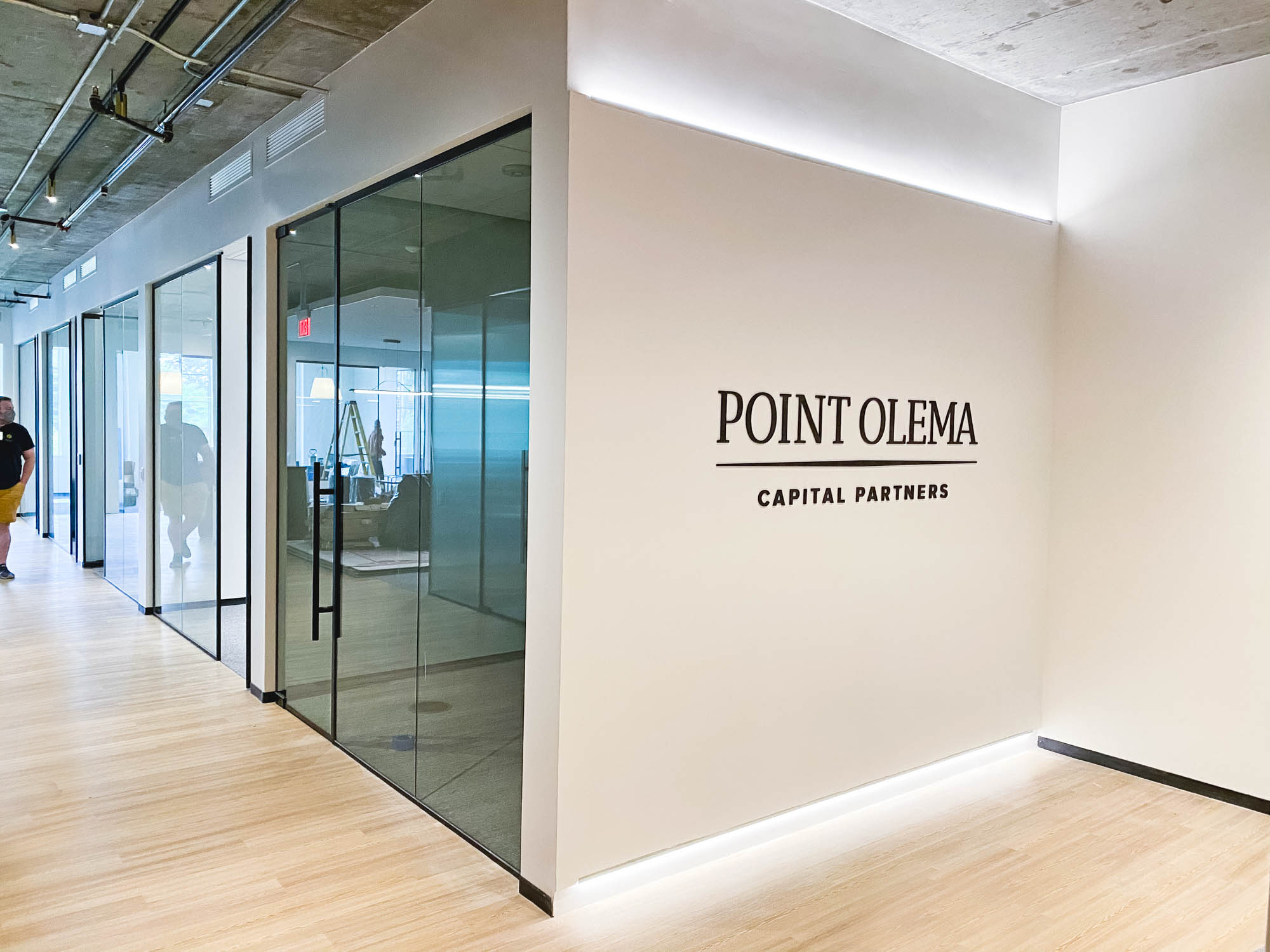 Simple black lobby sign on painted wall with uplights for the San Francisco office of Point Olema Capital Partners. Simple black lobby sign on painted wall with uplights for the San Francisco office of Point Olema Capital Partners.