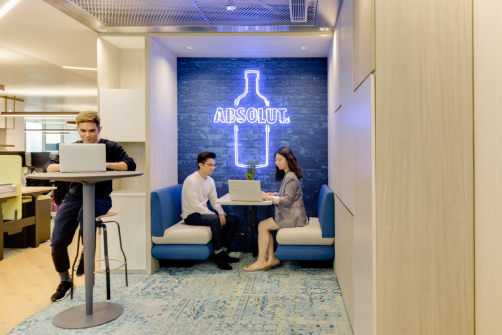 Blue neon Absolut vodka sign in office booth seating at the Pernod Ricard Offices in Hong Kong. (Photo: Harold de Puymorin)