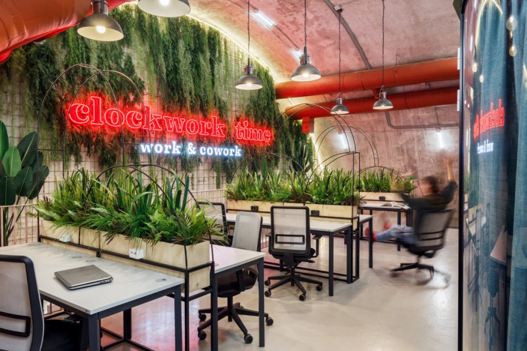 Red neon sign with greenery at Clockwork Time, a co-working space in St. Petersburg, Russia. (Photo: Anton Ivanov)