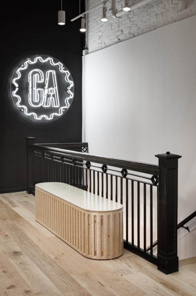 White neon sign with clear backer in black painted wall at the General Assembly headquarters in Washington DC. (Photo: Trent Bell)