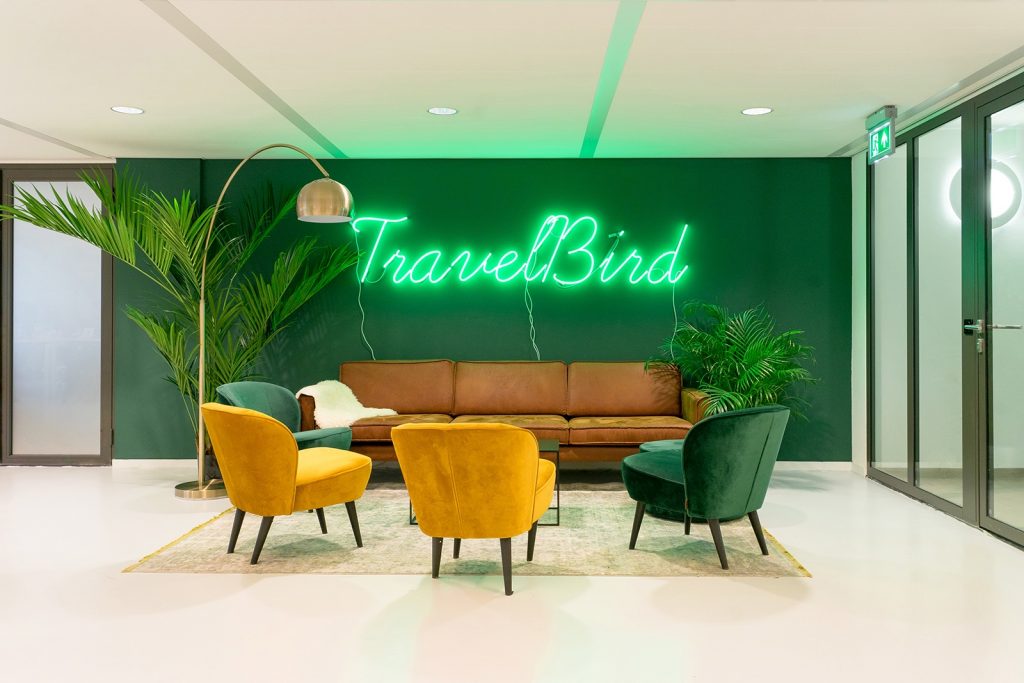 Green neon sign on green painted wall for the lobby of Travelbird, in Amsterdam, Netherlands. (Photo: June Studio Amsterdam)